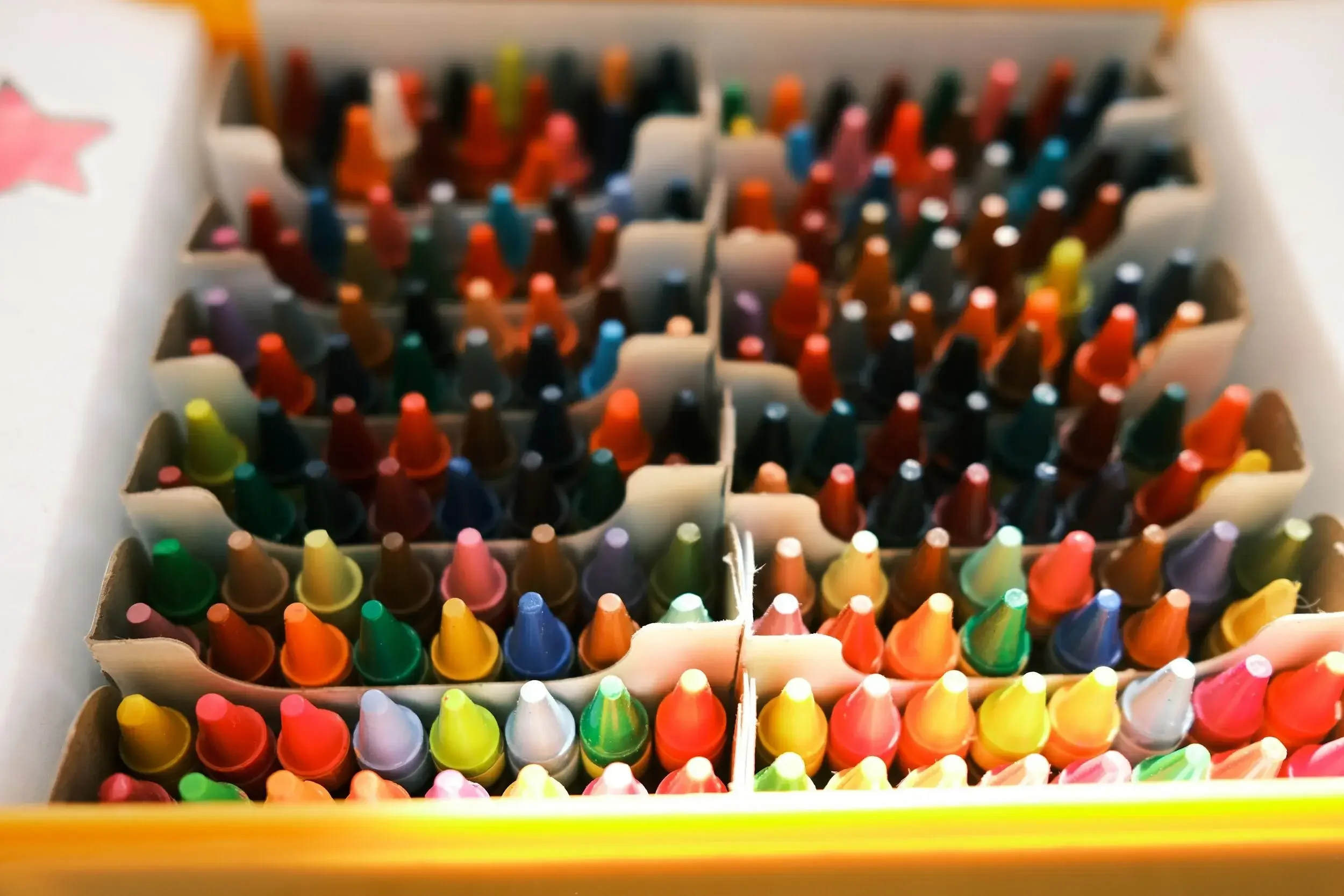 Multiple packs of colorful felt tip markers in a plastic container.