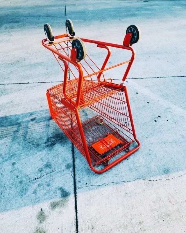 Bright orange shopping cart — Neighbours grocery store Tofino BC