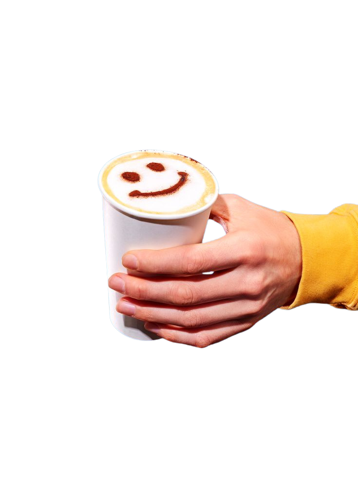 Latte art smiley face held in hand — best coffee Tofino BC