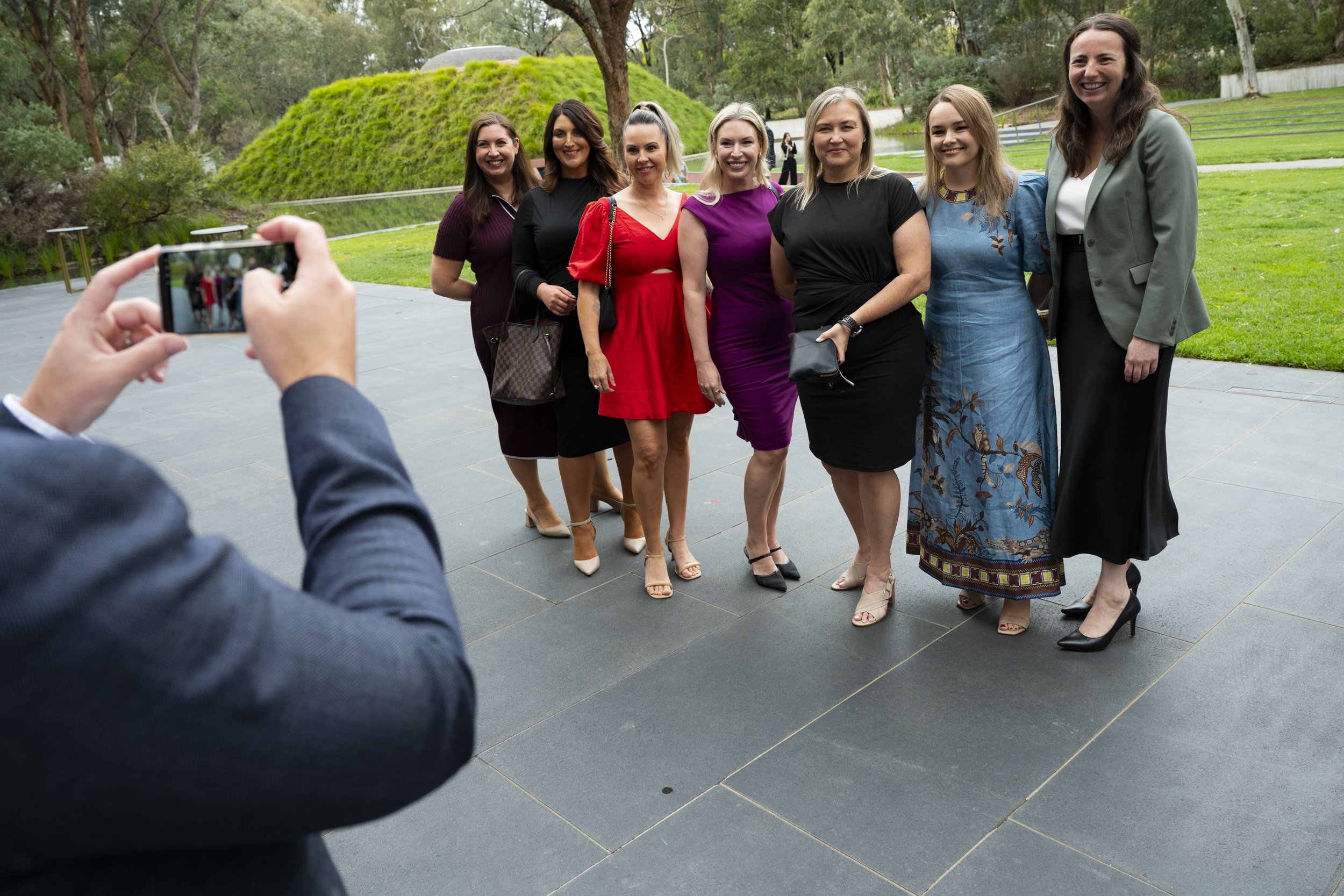 Group of women posing for a photo outdoors during a corporate event at the National Gallery of Australia