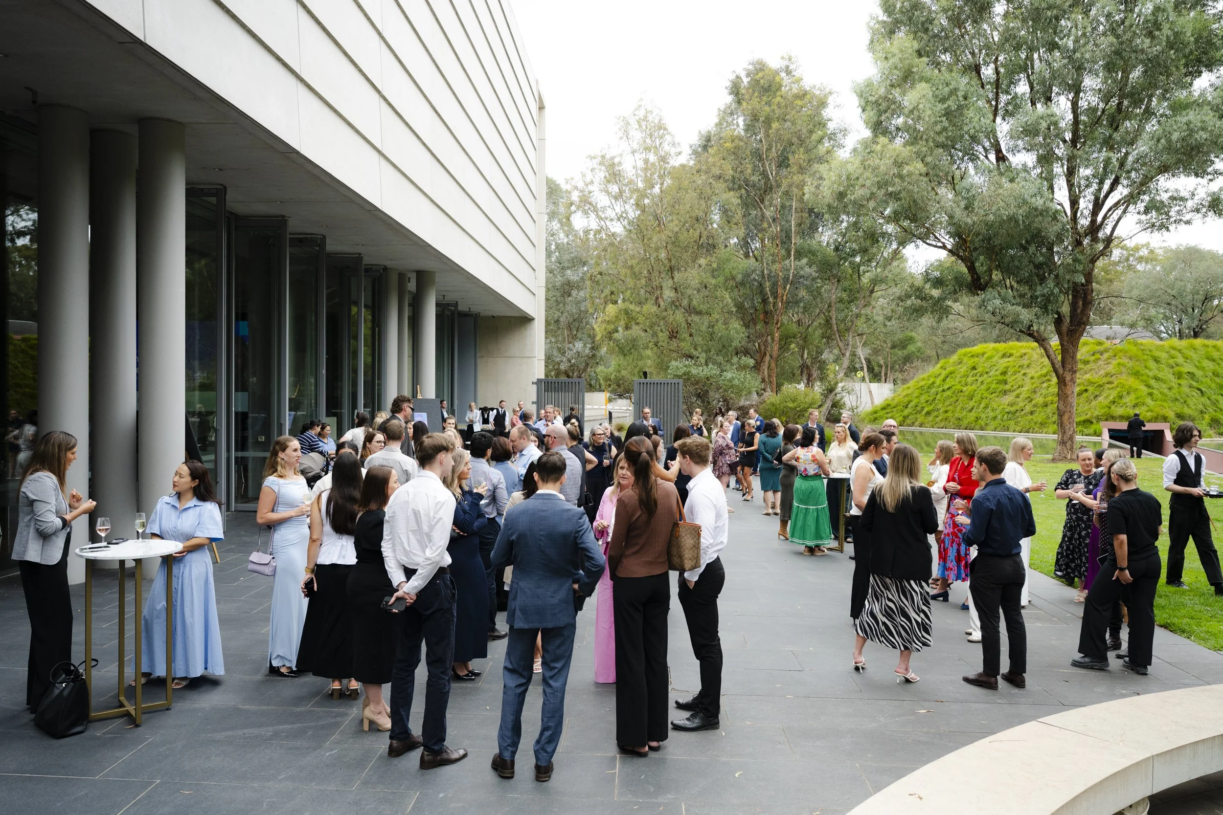Corporate event guests networking outdoors on the terrace of the National Gallery of Australia, Canberra