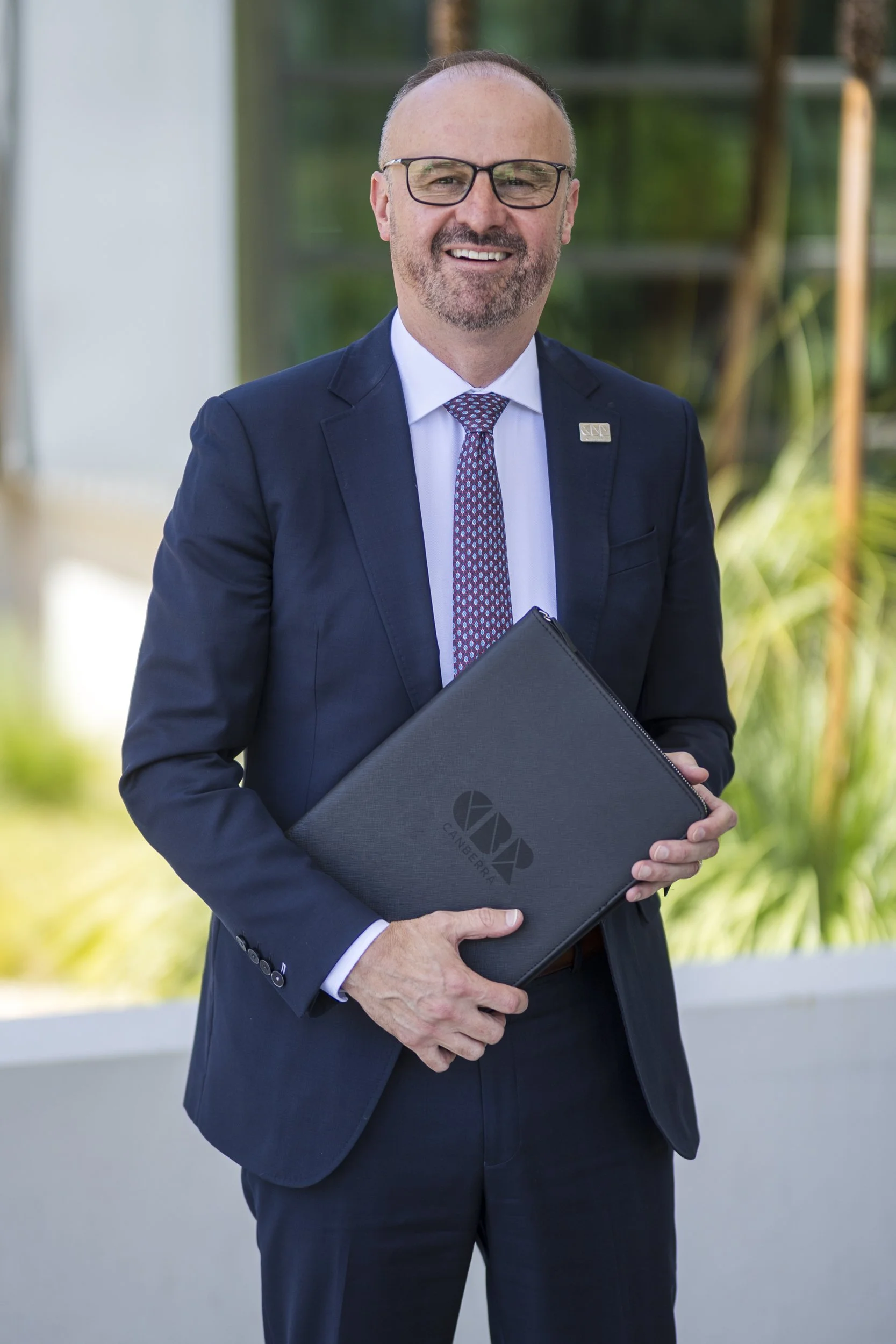 Portrait of Chief Minister of ACT Andrew Barr, shallow depth of field in front of modern building