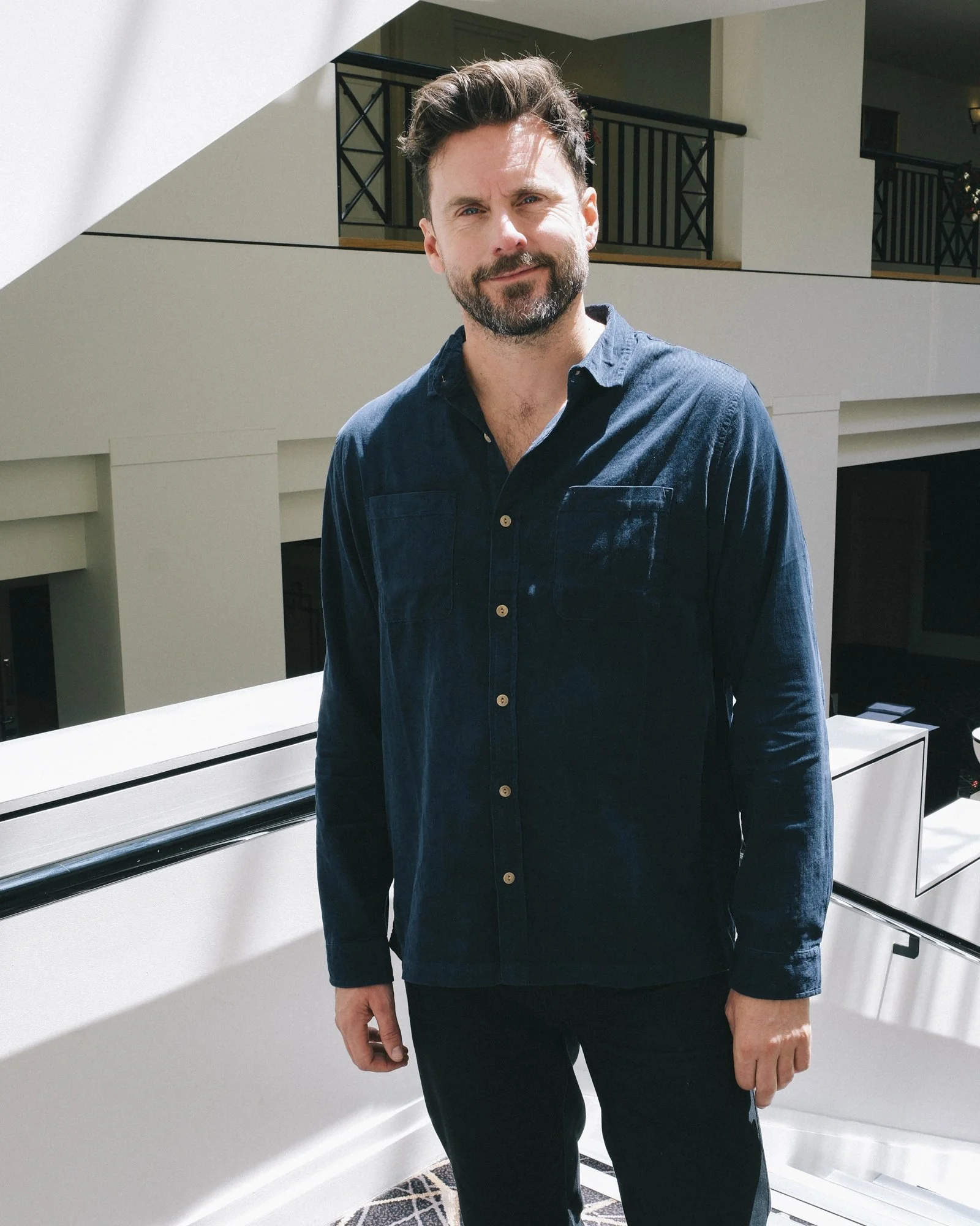Portrait of Dave Thornton in a hotel atrium, natural light, taken at the Hyatt Canberra during a Property Council event