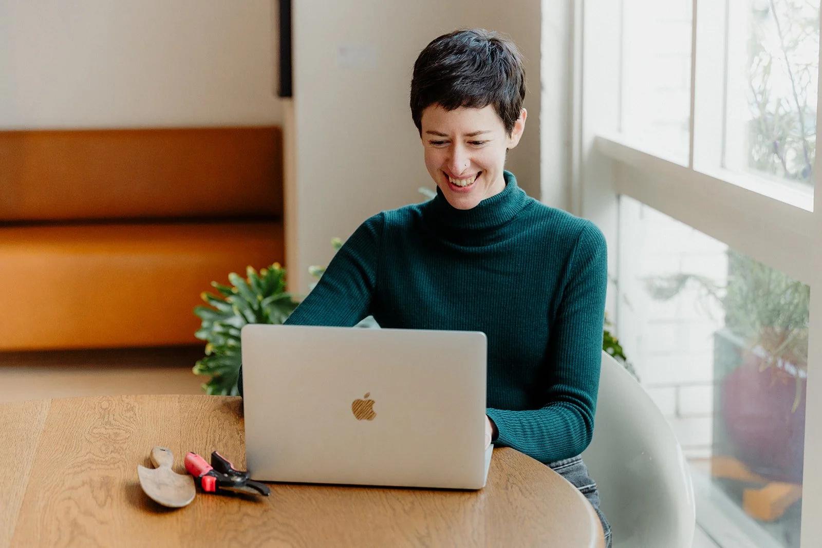 A woman having a conversation with someone on a laptop
