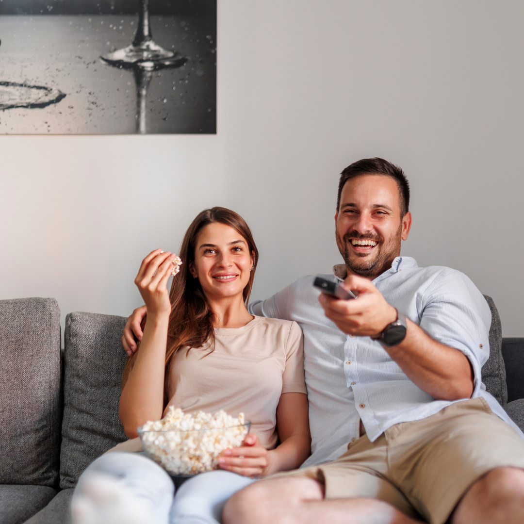 Image of people on the couch watching tv representing new years resolutions and anxiety therapy in Orlando.