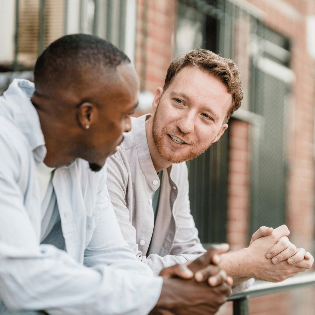 Image of two males chatting outside representing attachment therapy