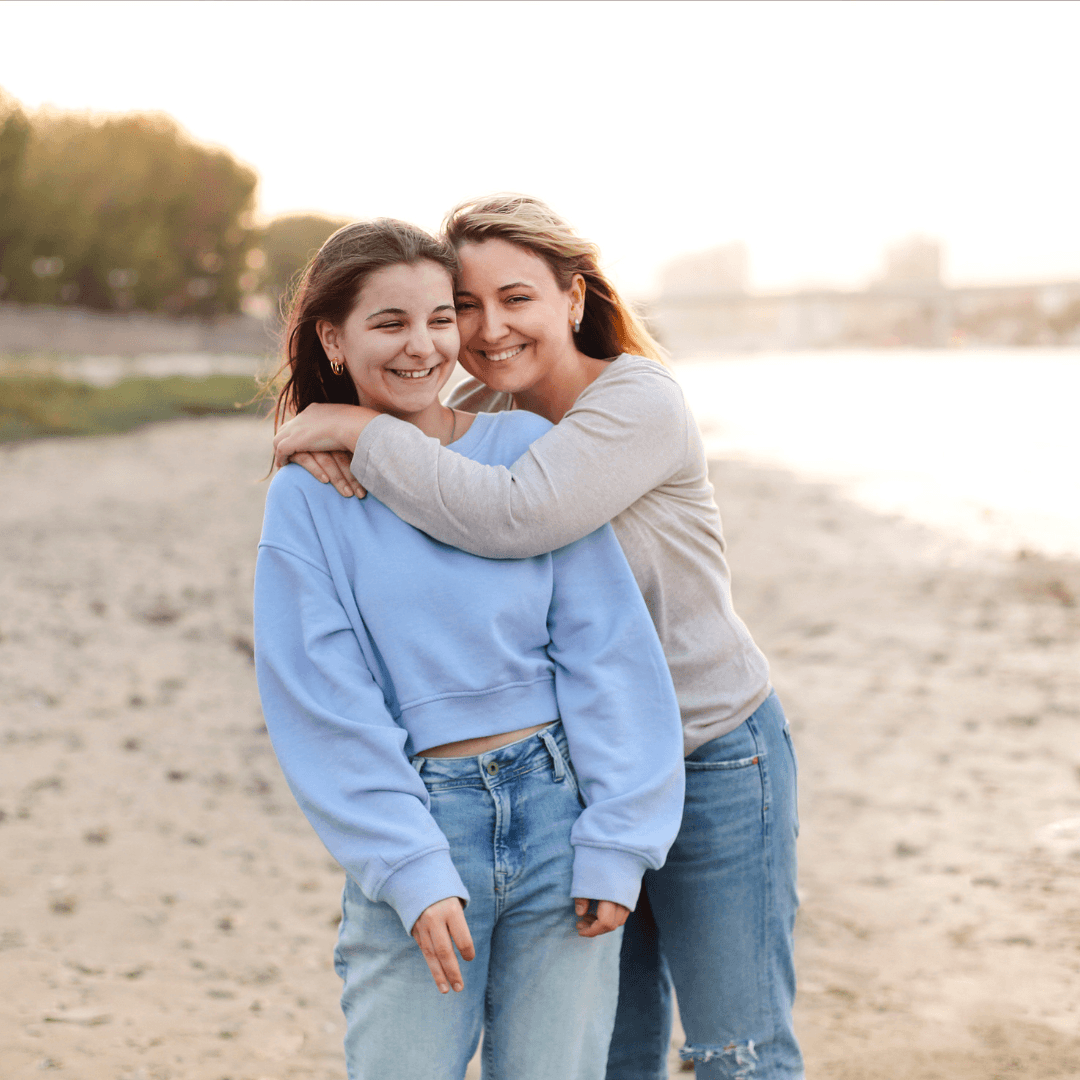 Image of a kid with parent hugging on the beach representing parenting therapy