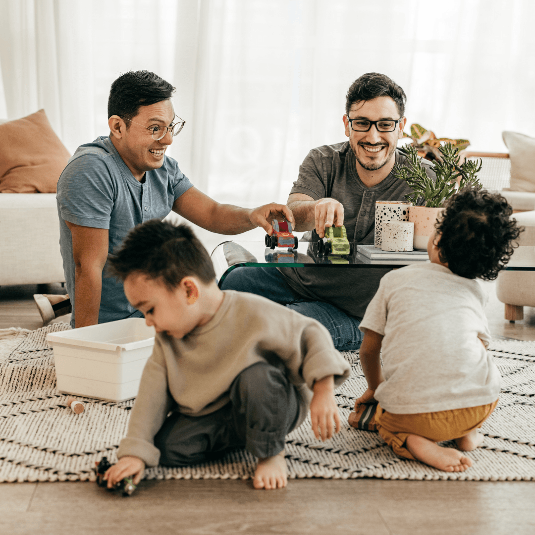 Image of a couple playing with kids in the living room representing attachment therapy