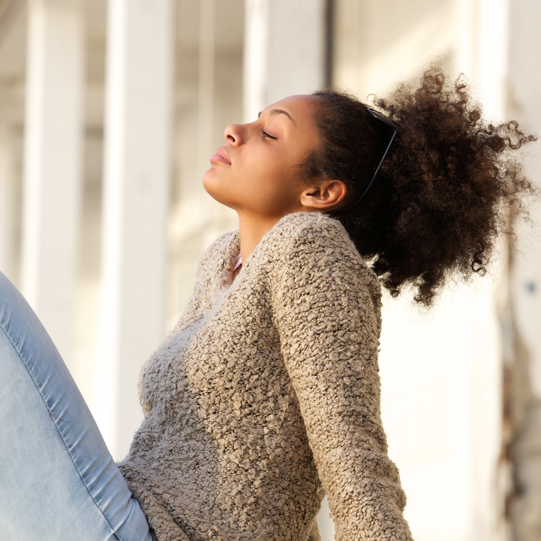 Image of a girl thinking outside with her eyes closed representing Anxiety Therapy Orlando