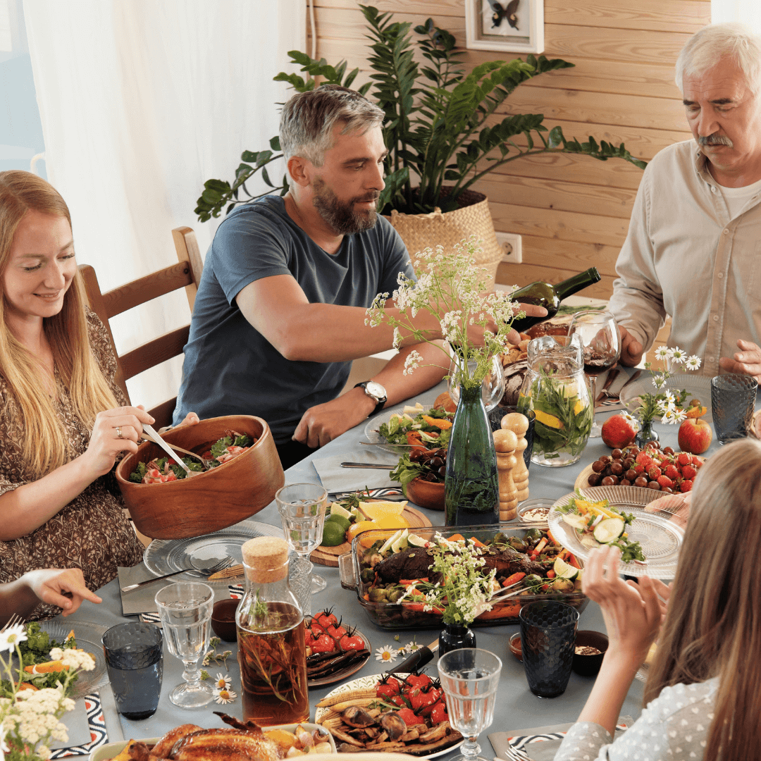 A family enjoying dinner together stressful holiday season, illustrating tips from an anxiety therapist in colonial town Orlando.