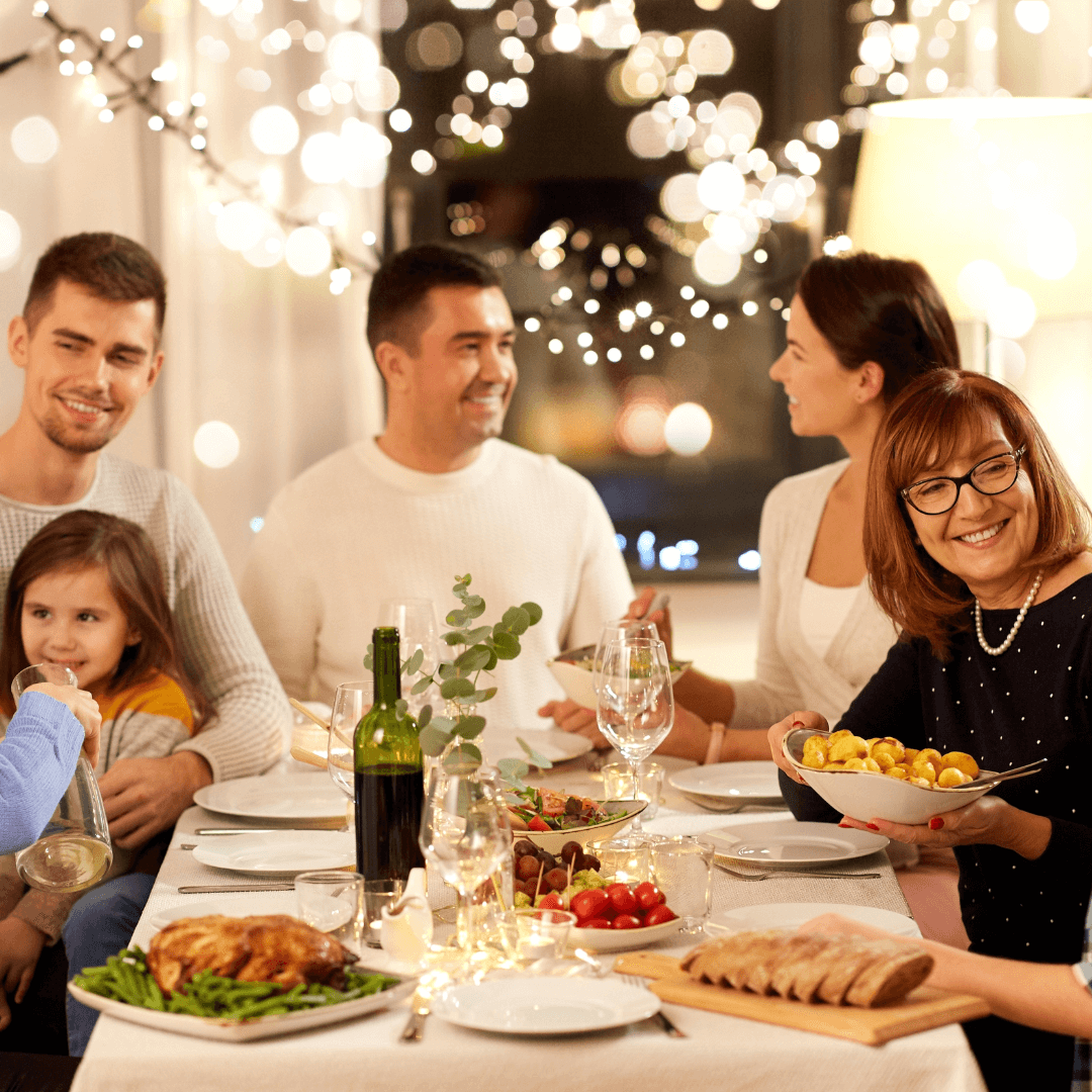 A family enjoying a nice dinner during stressful holiday season, illustrating tips from an anxiety therapist in colonial town Orlando.