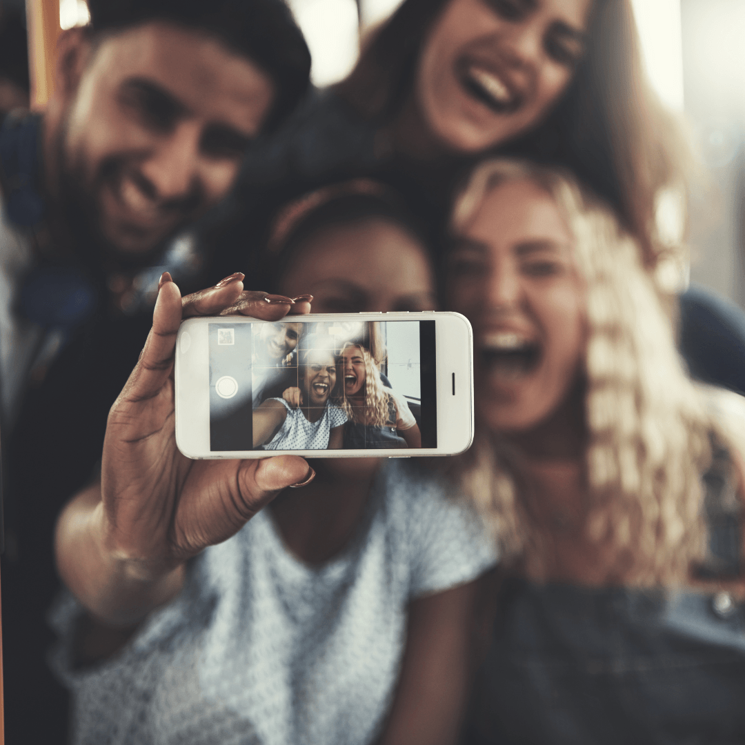 Image of friends taking a picture representing attachment therapy