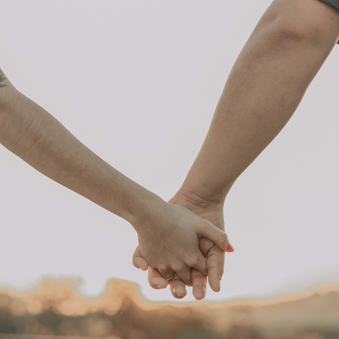 image of two people holding hands representing avoidant attachment