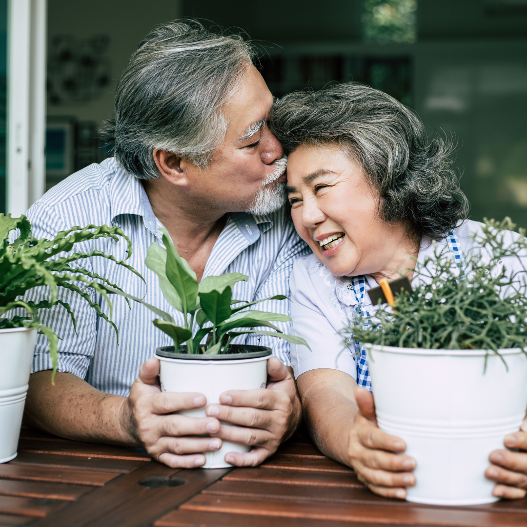 image of a couple holding plants representing avoidant attachment