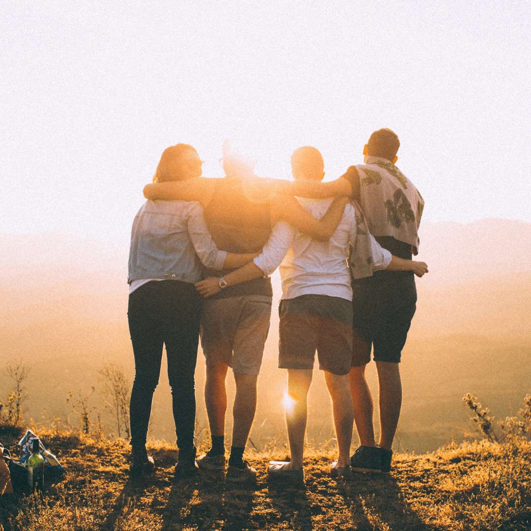 Image of friends hugging together in the sunset, representing Attachment Therapy Orlando