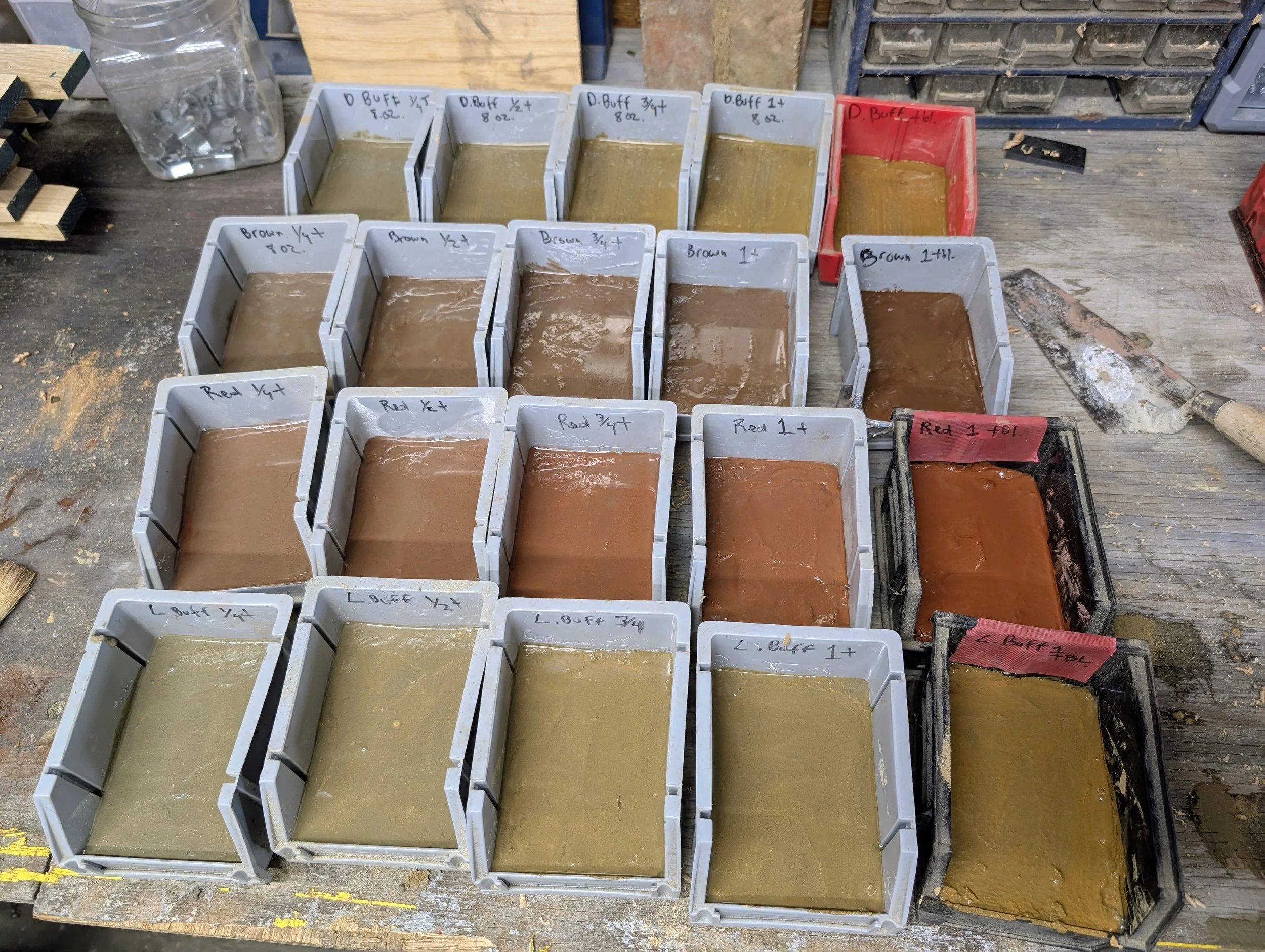 Mortar Pigment Test Grid | Pigmented mortar color samples in plastic bin molds with pigment-to-mix ratio notation