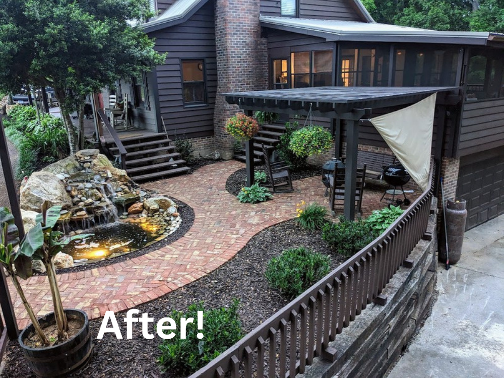 Residential Hillside Hardscape Transformation (After View) | Completed terraced transformation featuring a timber retaining wall, custom dark-stained pergola, illuminated fish pond with tiered waterfall, and a herringbone reclaimed brick paver patio 