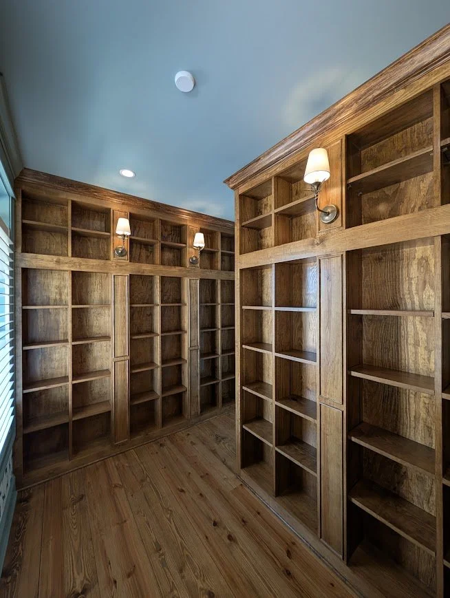 Custom Built-In Library Casework | Floor-to-ceiling stained timber cabinetry with integrated sconce lighting | Residential Installation