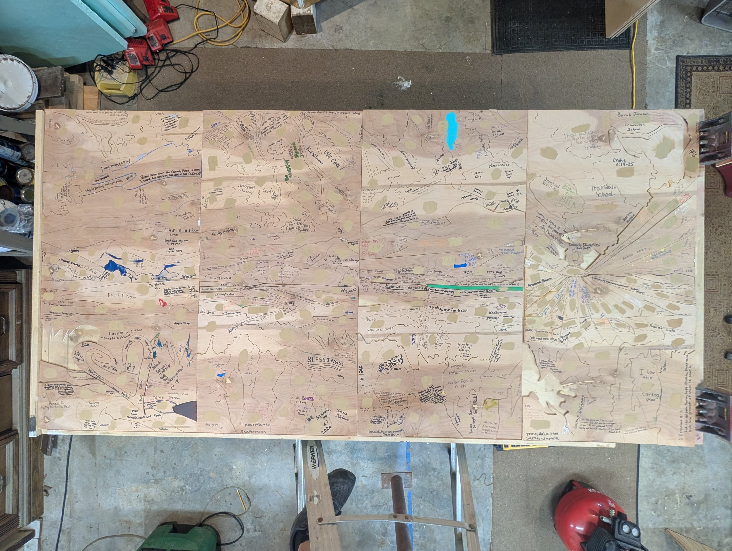 Mosaic of Hope (Process Detail) | Reverse side of assembled 4' × 8' panel structure displaying handwritten signatures and messages of hope from community participants