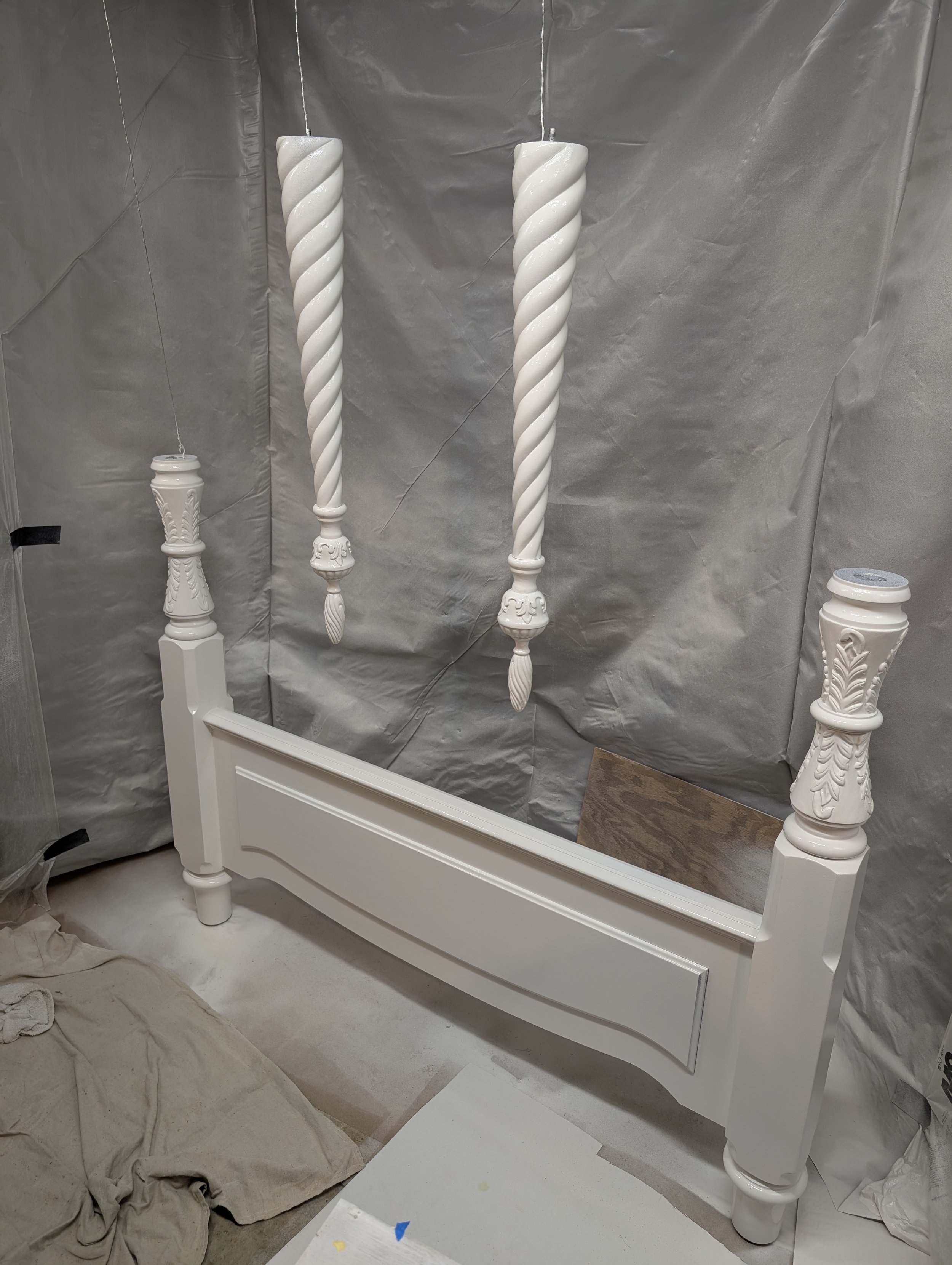 Four-Poster Bed Refinishing (In Progress) | Spray booth setup with suspended turned posts for complete enamel refinishing