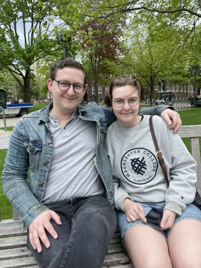 John and their sibling Skye on a park bench.