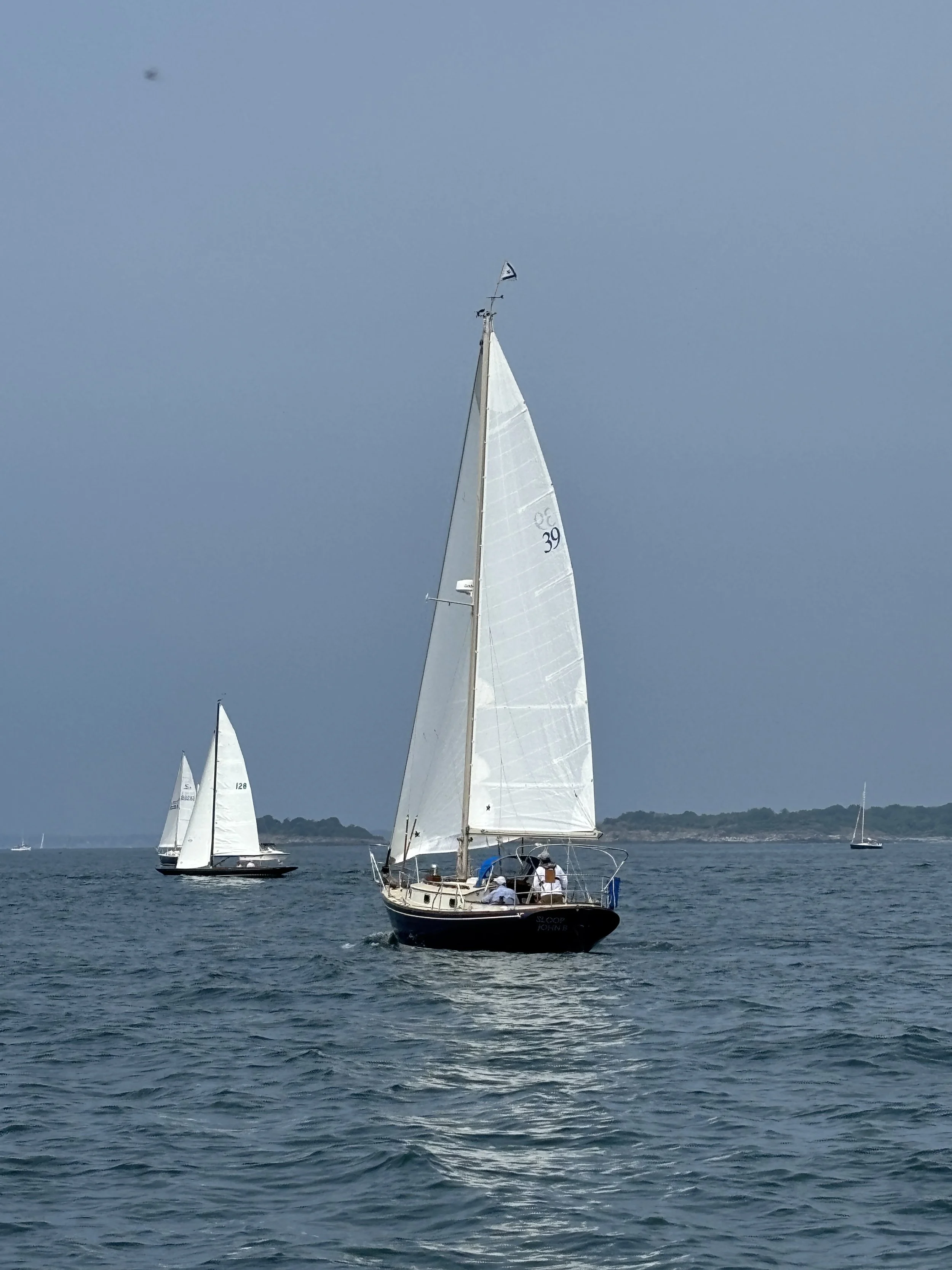 Sloop John B, a blue-hulled sailboat with Jib and Mainsail unfurled.