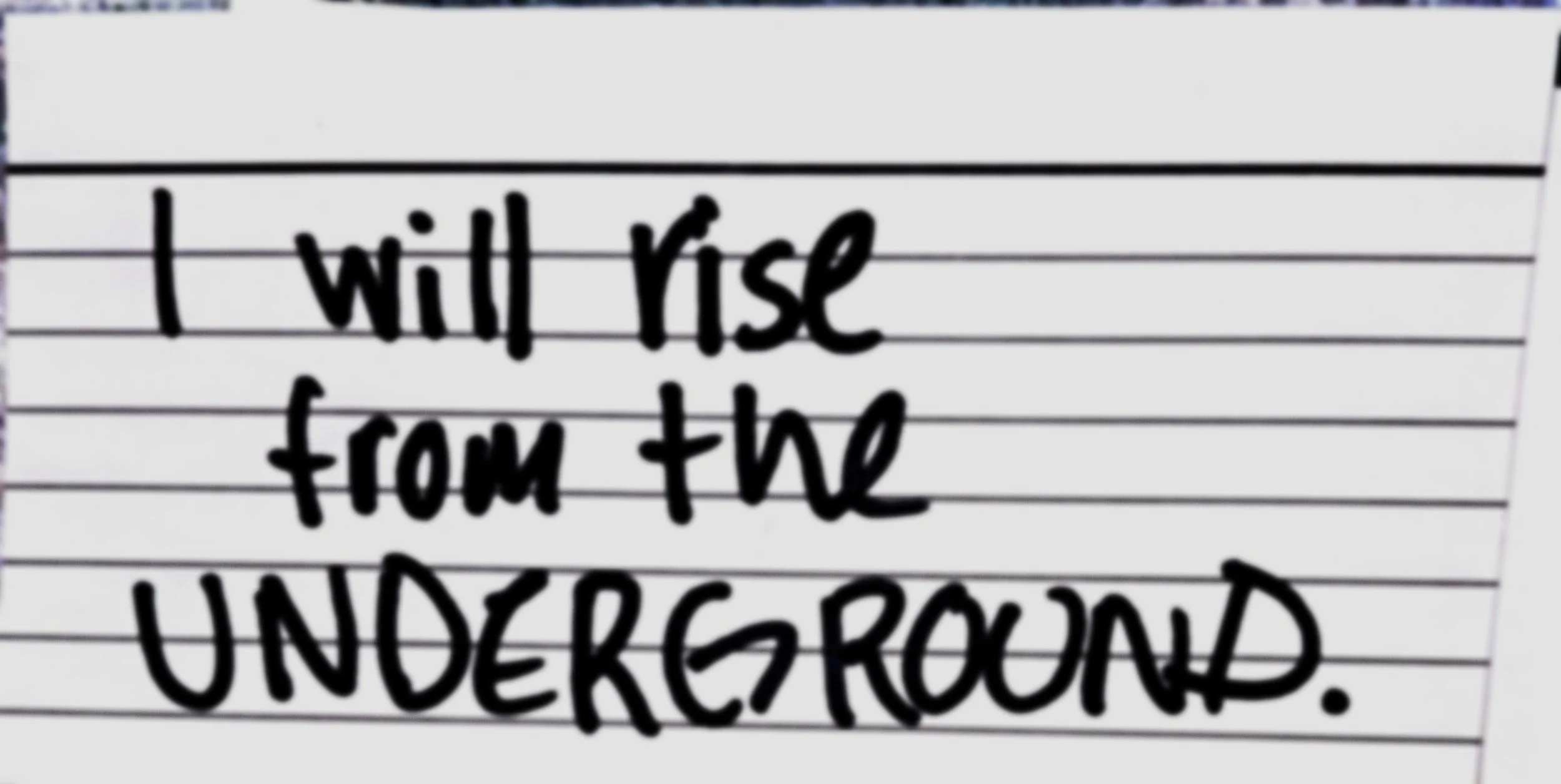 Notecard with writing that reads "I will rise from the underground."