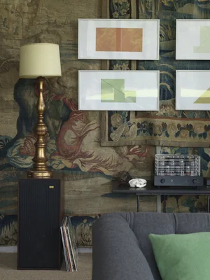 Details of living room with antique faded wallpaper