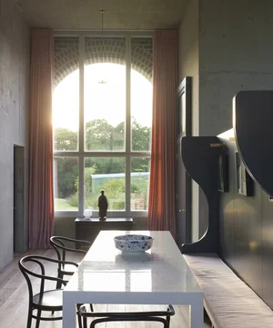 Doing area with arched windows looking out into fields 