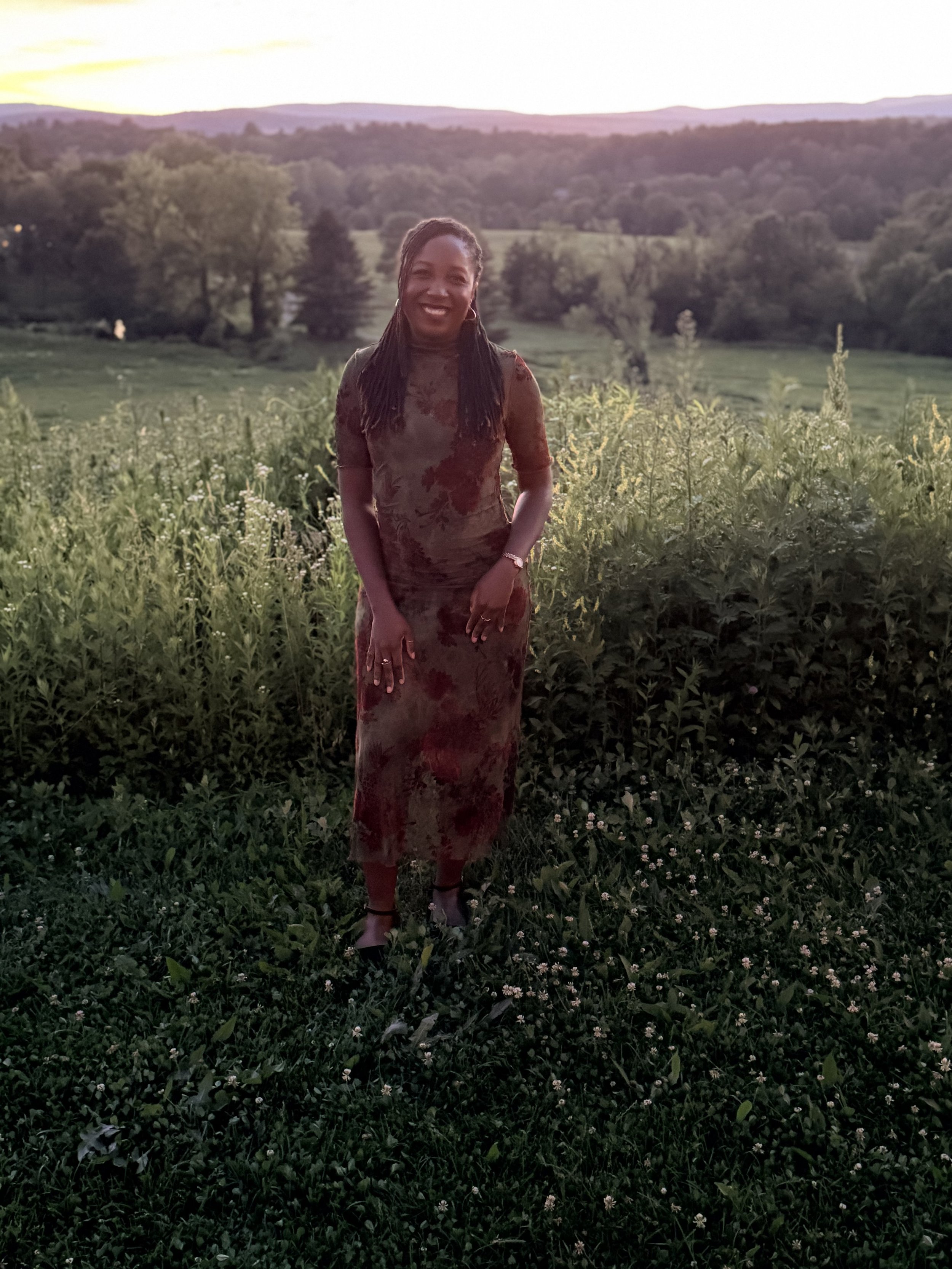 Jessica Thomas, LMHC, first-generation Haitian-American therapist, outdoors at golden hour