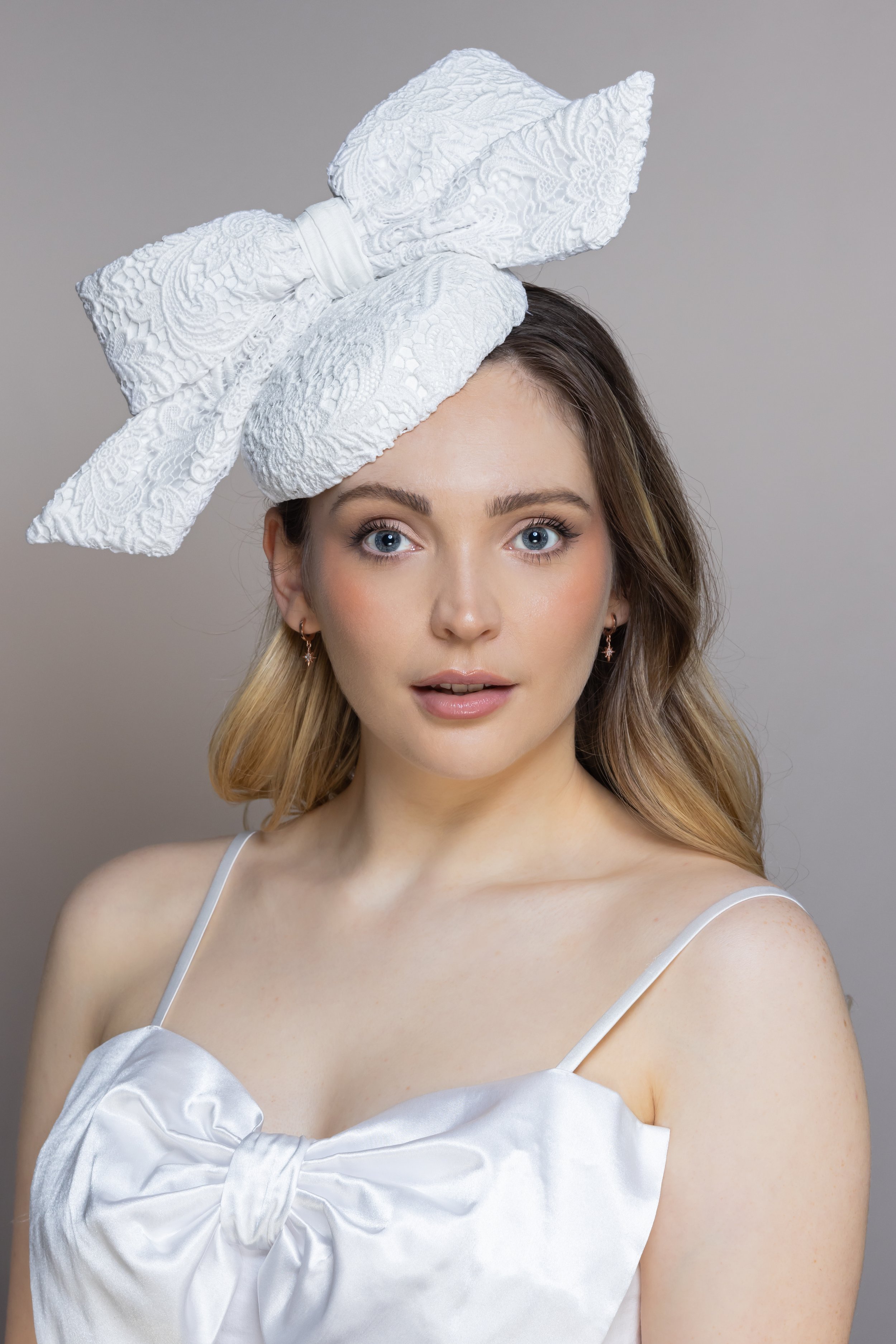 CONNIE, Bridal button hat with guipure lace and large bow to one side, ideal for a modern bride.