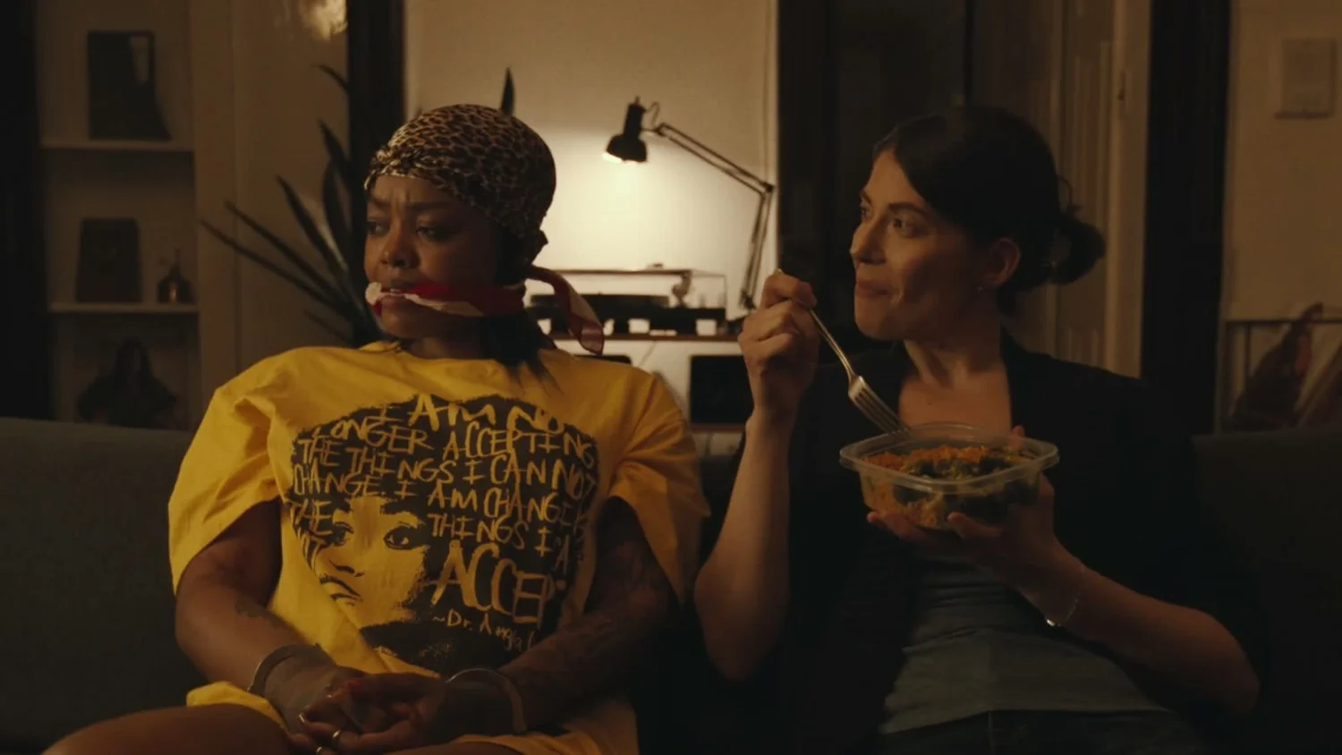 Two women on a couch at night, from You Ain’t Gotta Go Home.