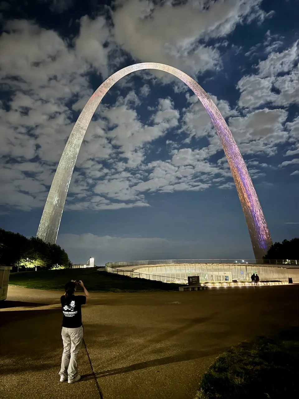 St. Louis Gateway Arch at night. Ari taking a photo of it.