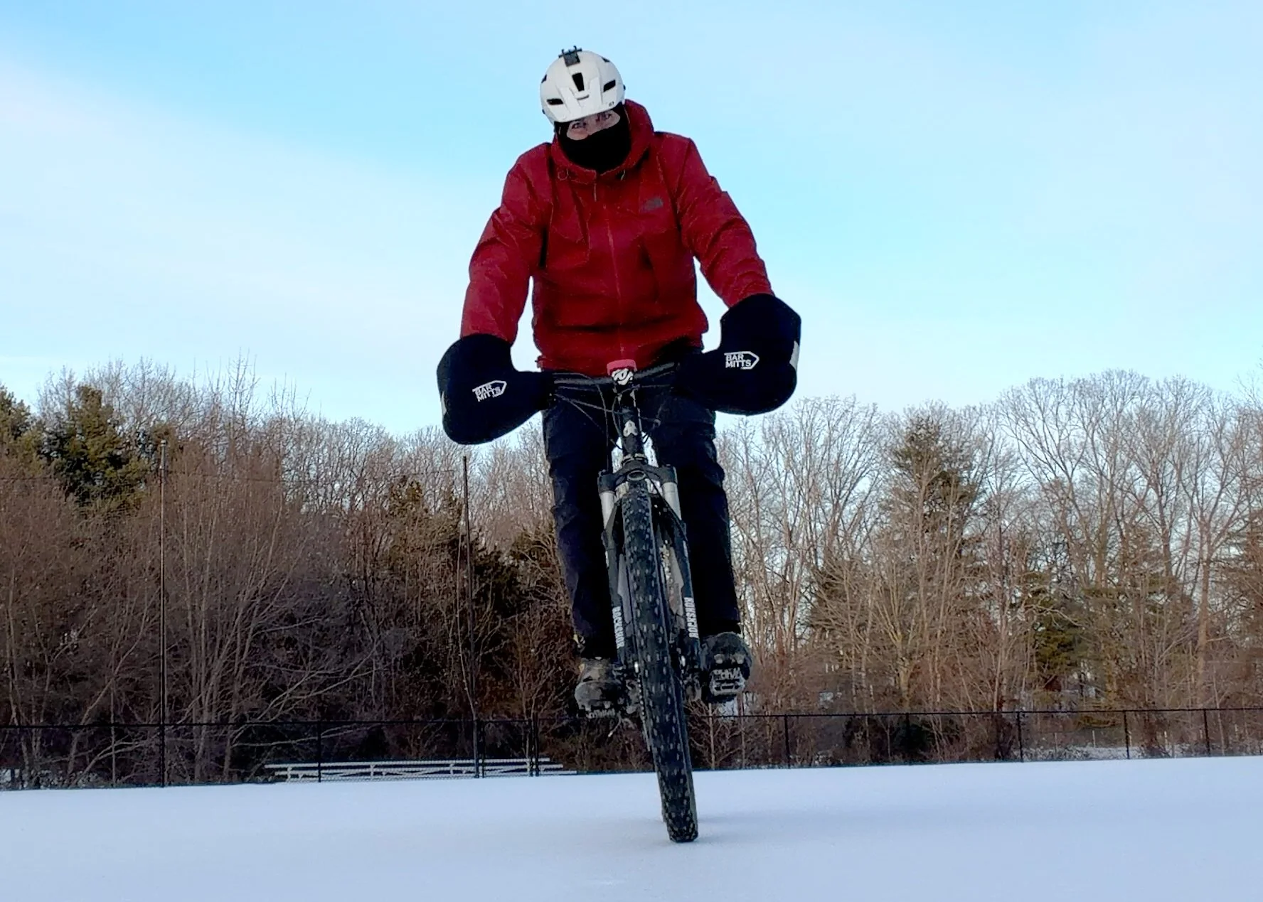 mountain biker riding on snow packed landscape