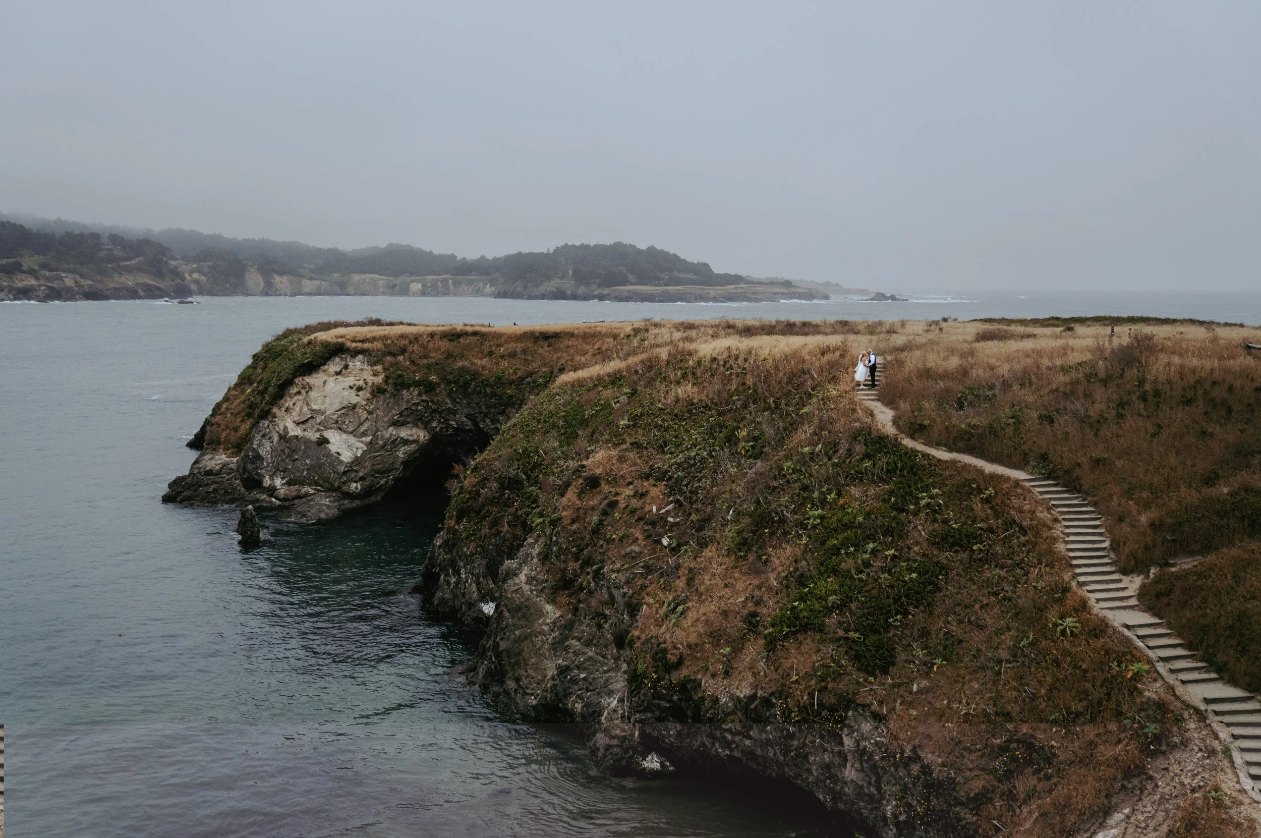 bride and groom overlooking the coastline in Mendocino California