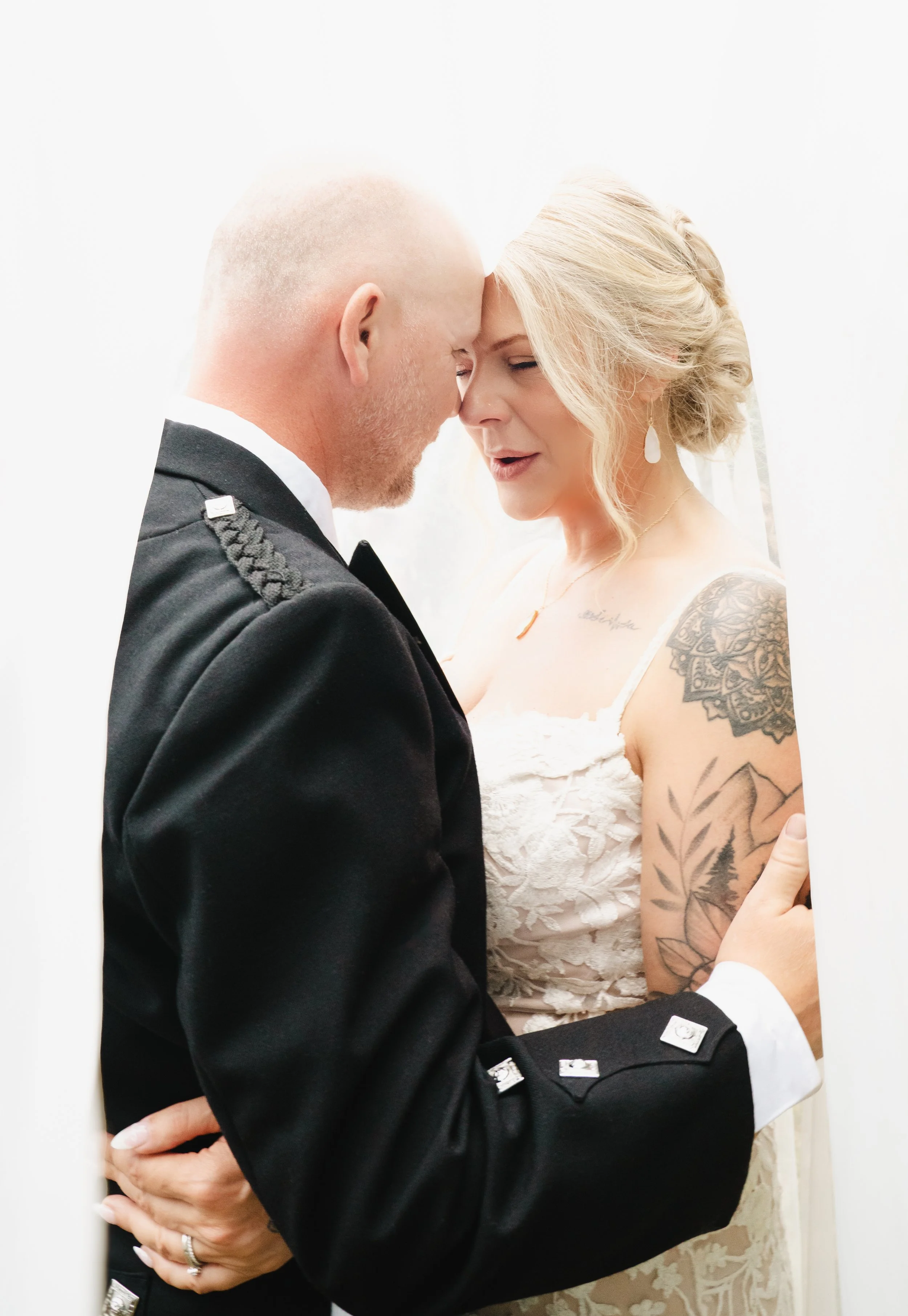 A bride and groom under a veil