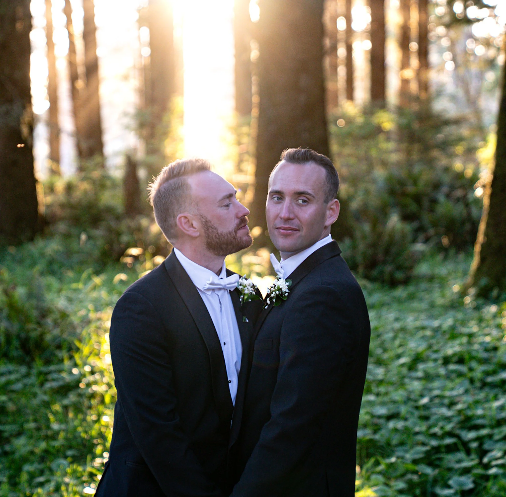 A gay couple in a forest posing for their wedding photos at Crook Point in Southern Oregon