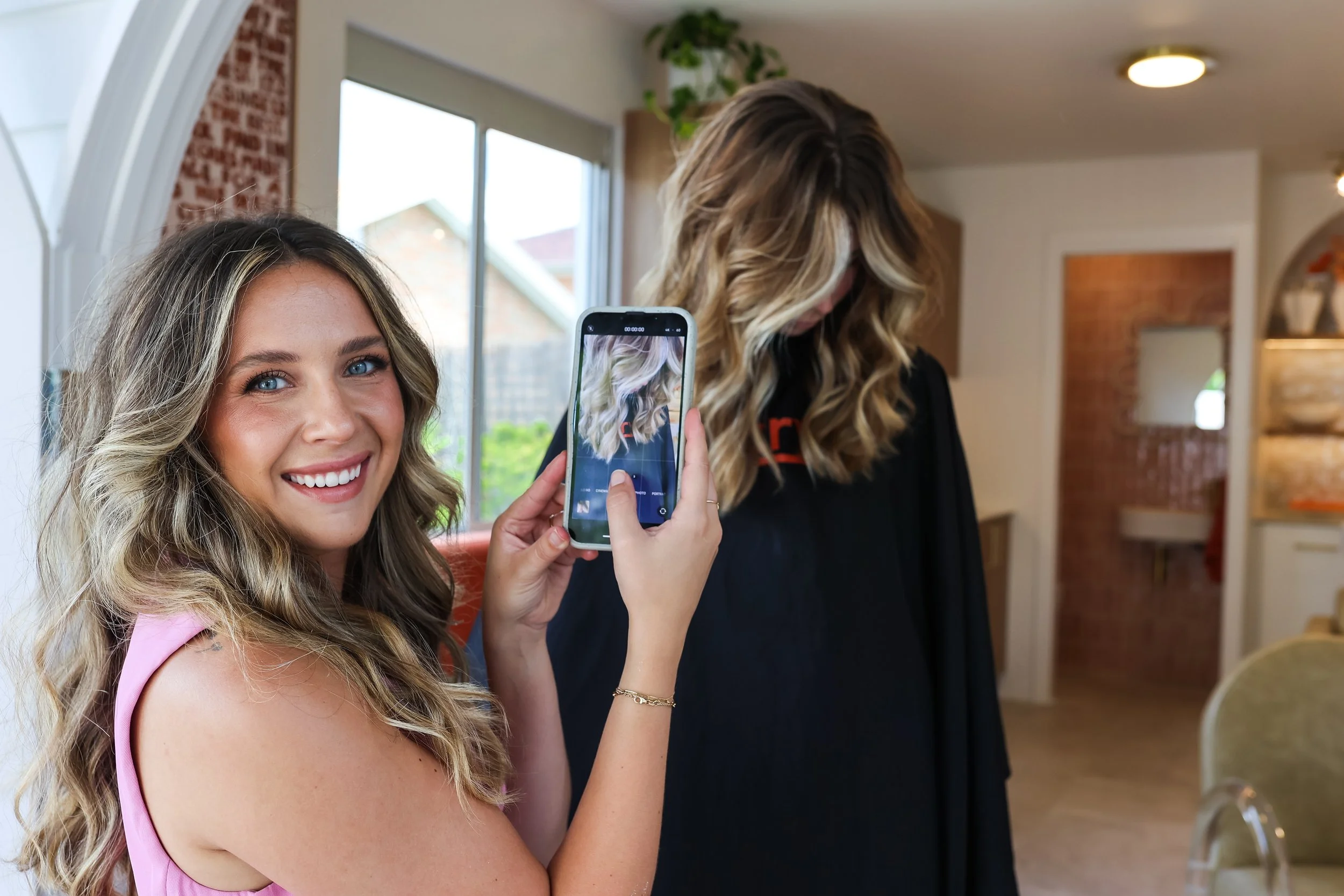 Girl wearing brown blazer, painting foils on customers hair