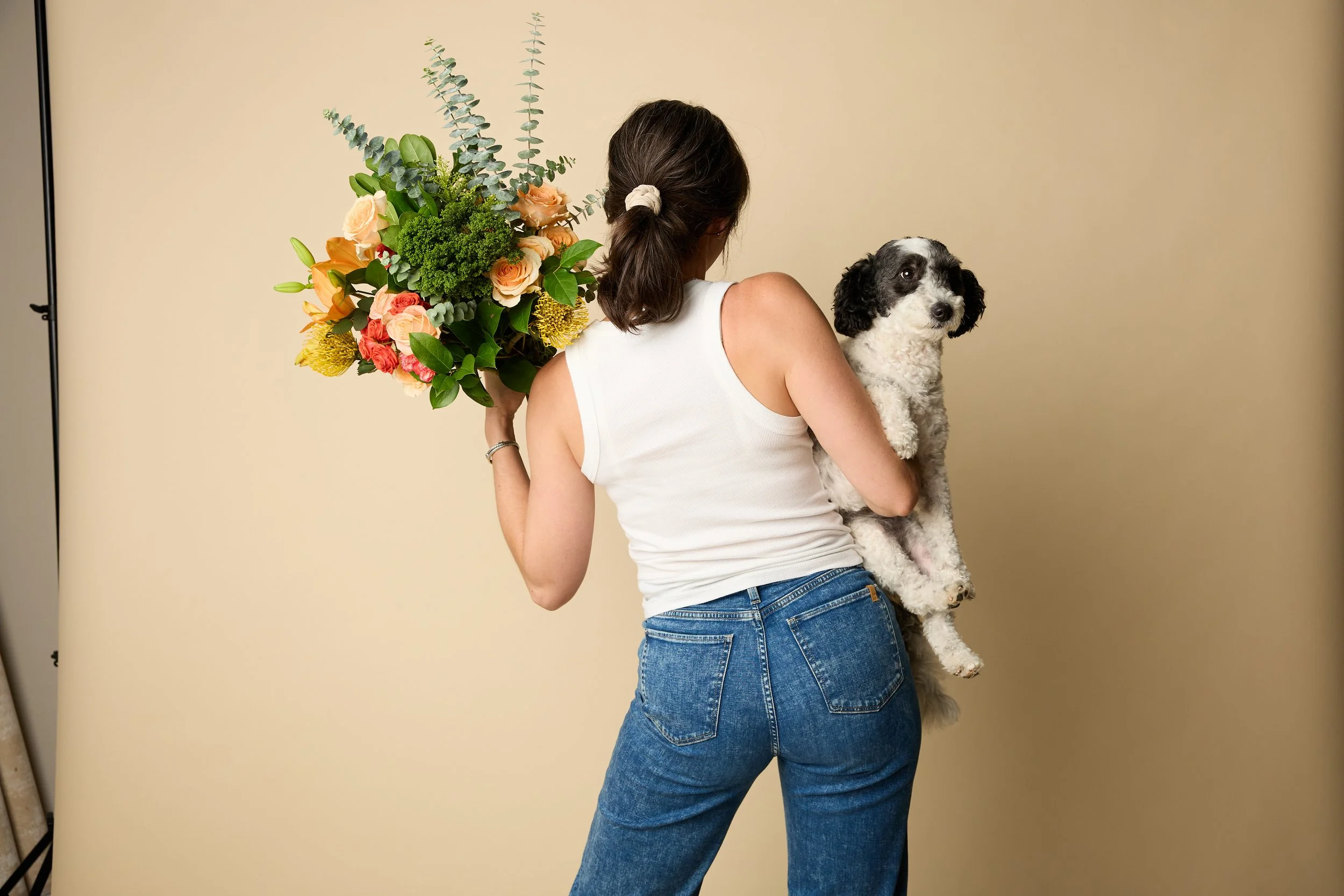 Lillian from behind with flowers and her dog
