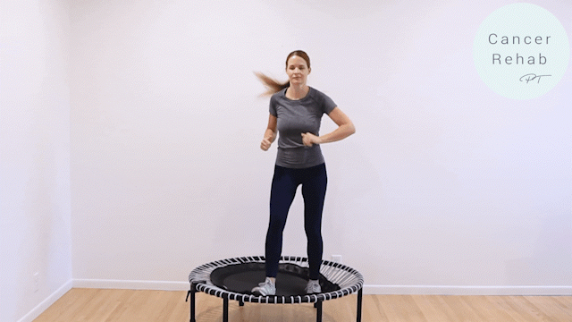 A woman mid rebounder workout exercises on a white background, jumping twice to the side, crunching her knee to her elbow on the left, then repeating on the right.