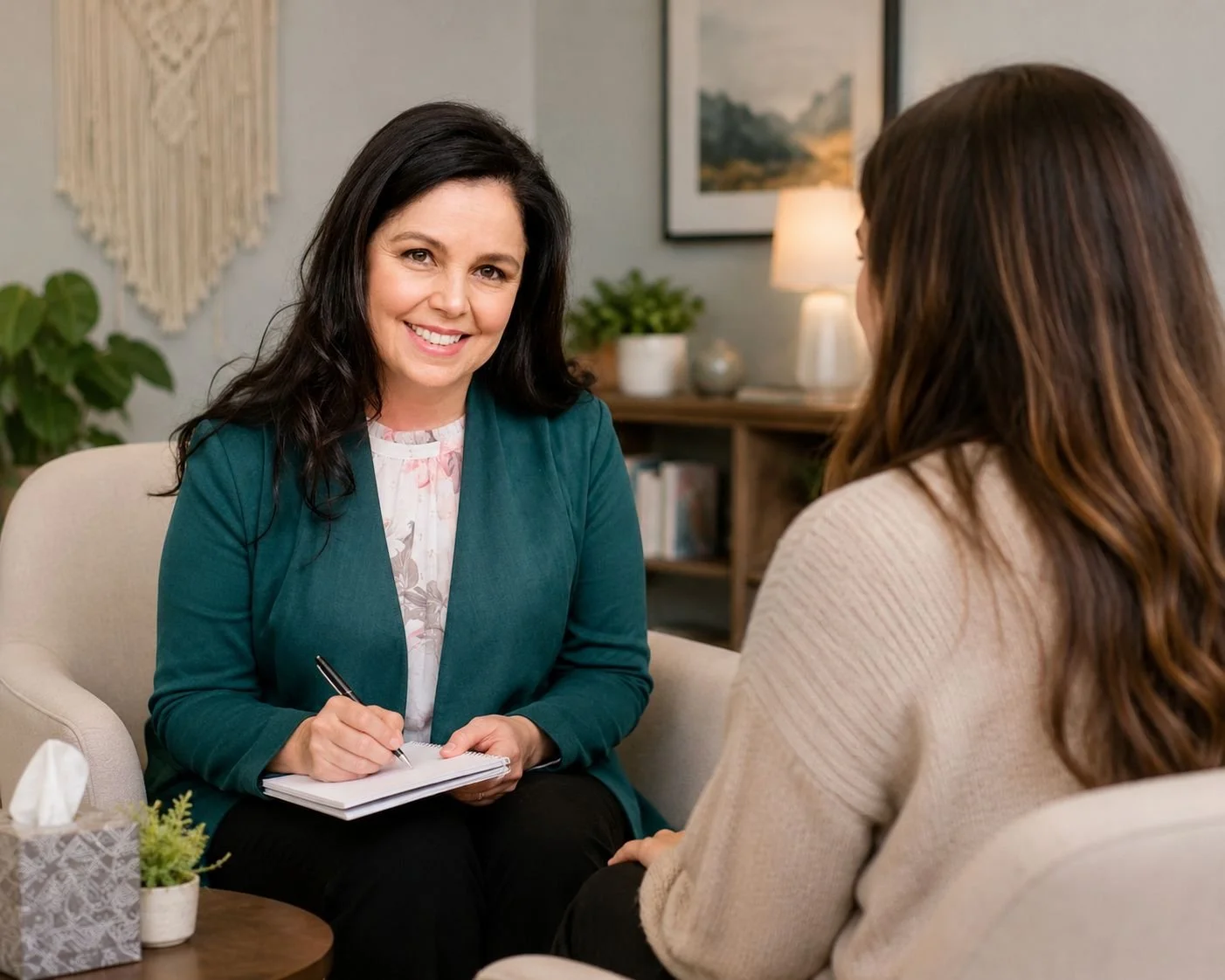 Claudia taking notes during a therapy or counseling session with a client.