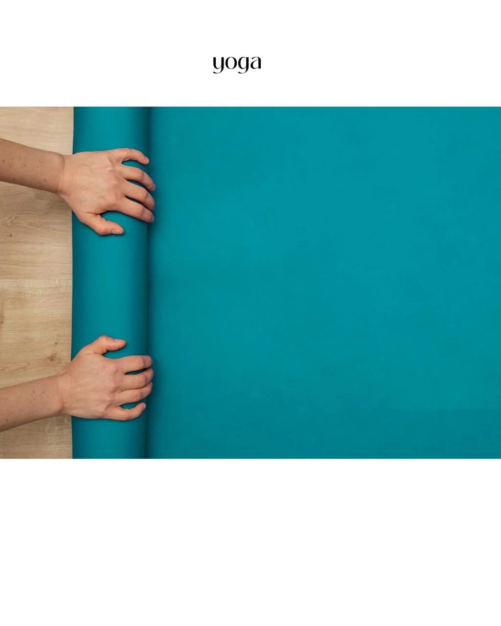 Someone rolling out a blue yoga mat on a wooden floor.