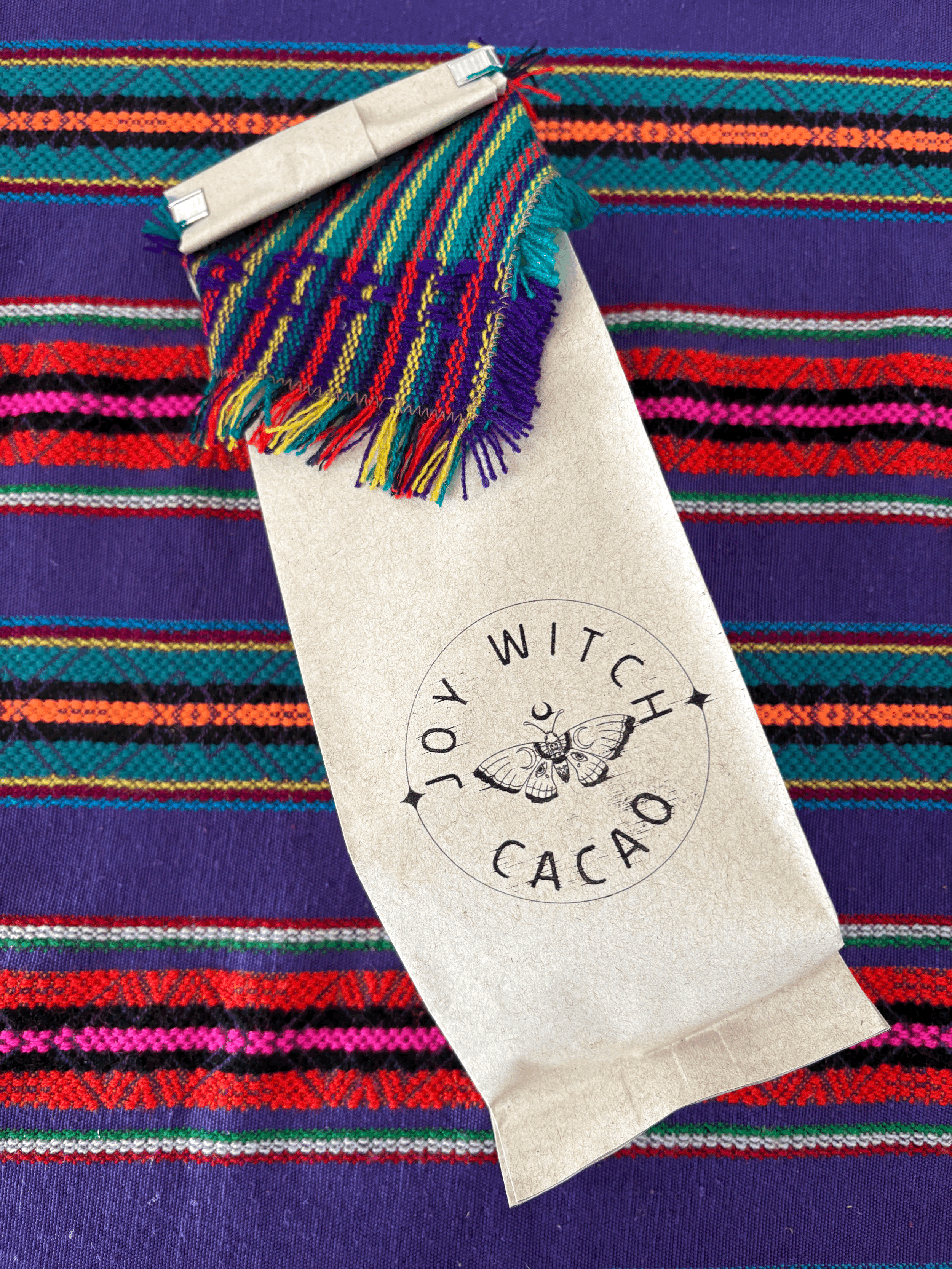 Joy Witch Cacao packaging featuring a moth and handwoven Salvadoran textile—organic cacao for ritual and ancestral remembrance