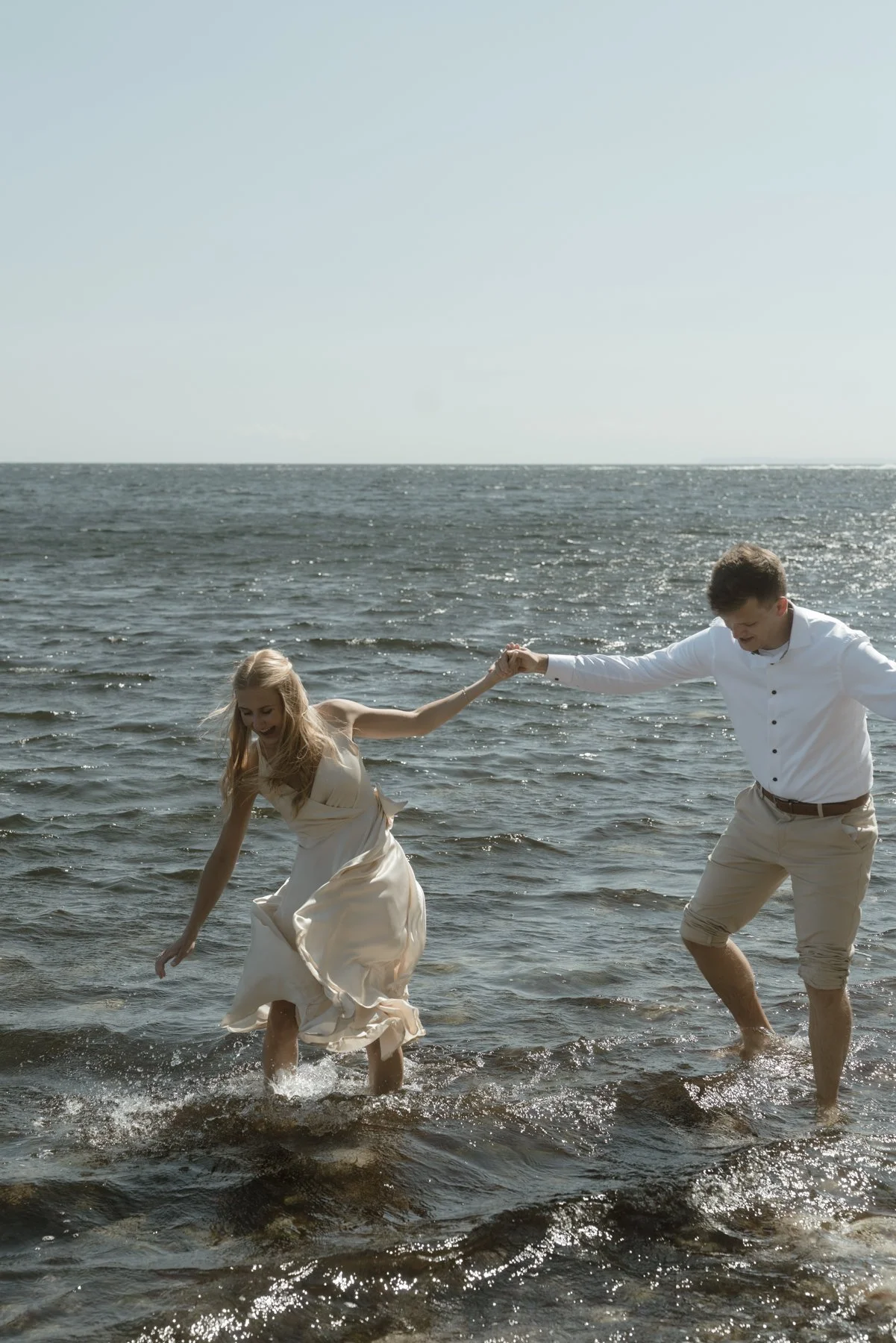 wedding couple walking in the sea