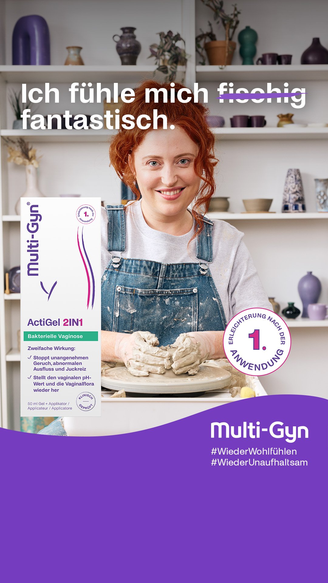 A woman with red hair, wearing a white shirt and denim apron, smiling at the camera in a kitchen setting, with shelves of vases and ceramics behind her. A box of Multi-Gyn ActiGell 2IN1 vaginal gel is displayed in the foreground.