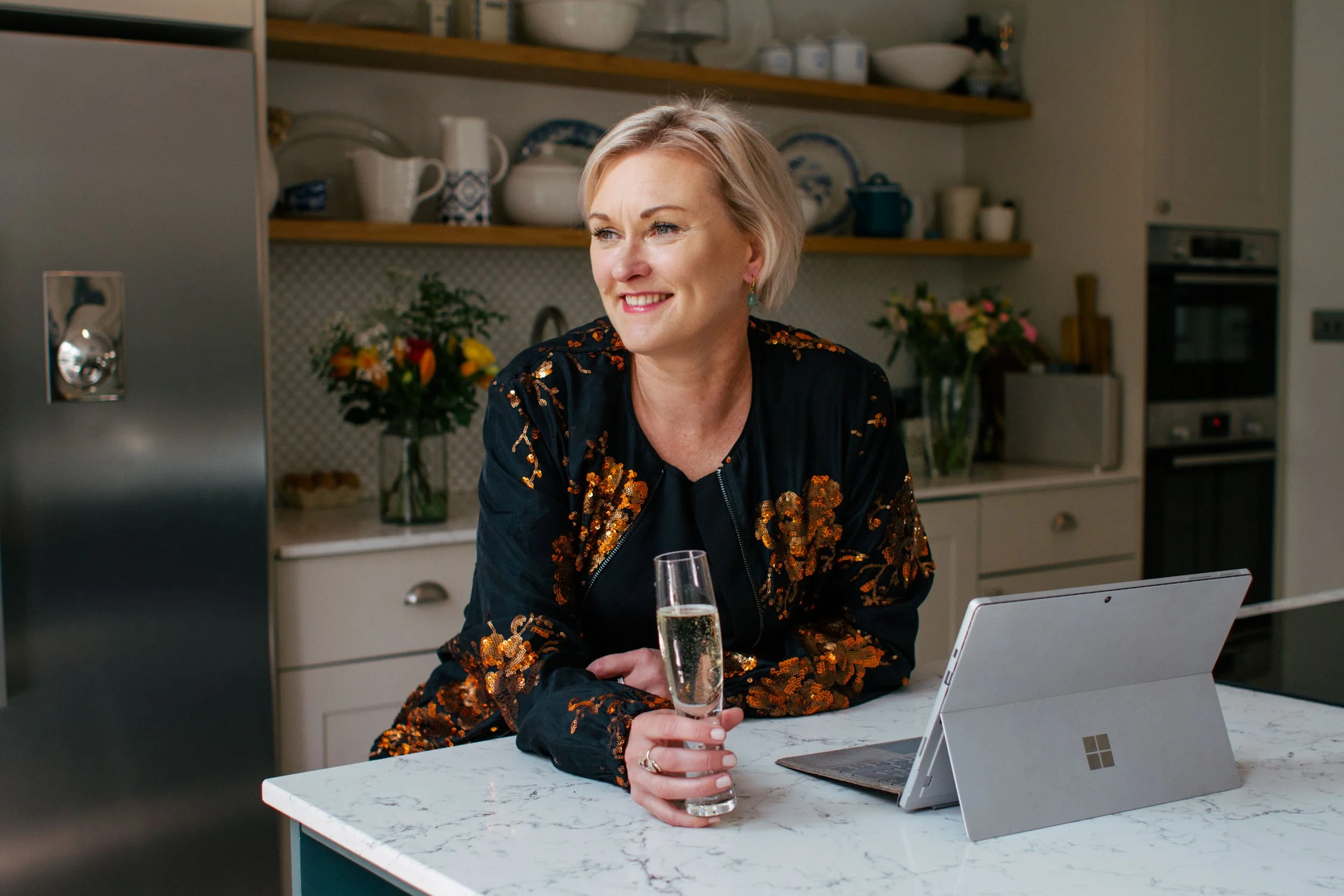 entrepreneur celebrating rebrand and website refresh with glass of champagne