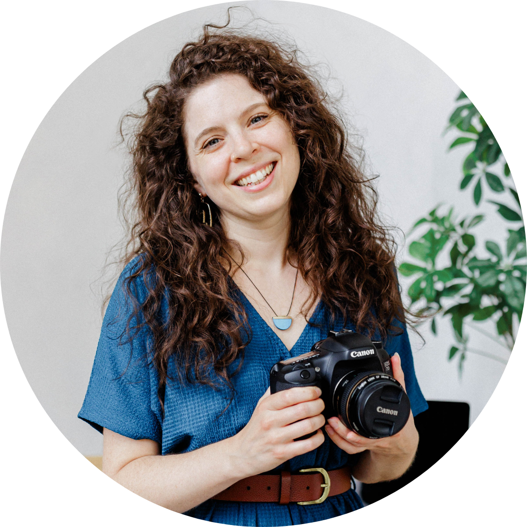 Lisa Gilby, brand photographer and visibility strategist, smiling and holding her camera