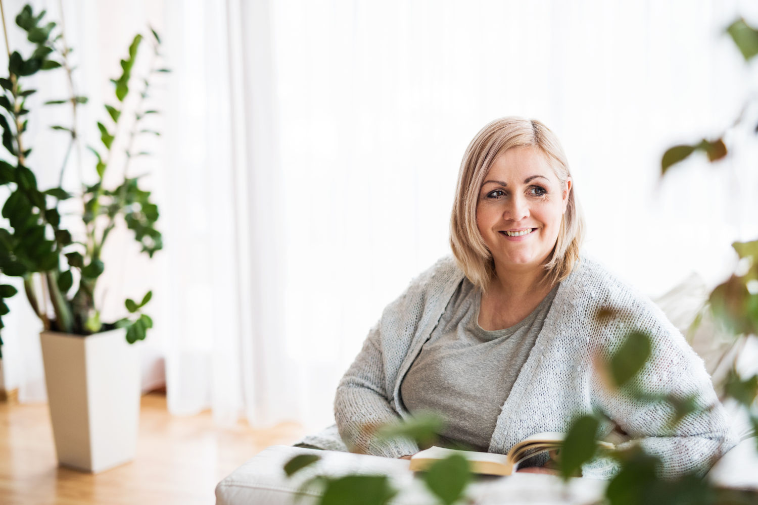 Woman reading health information at home, representing evidence-based weight management support for adults.
