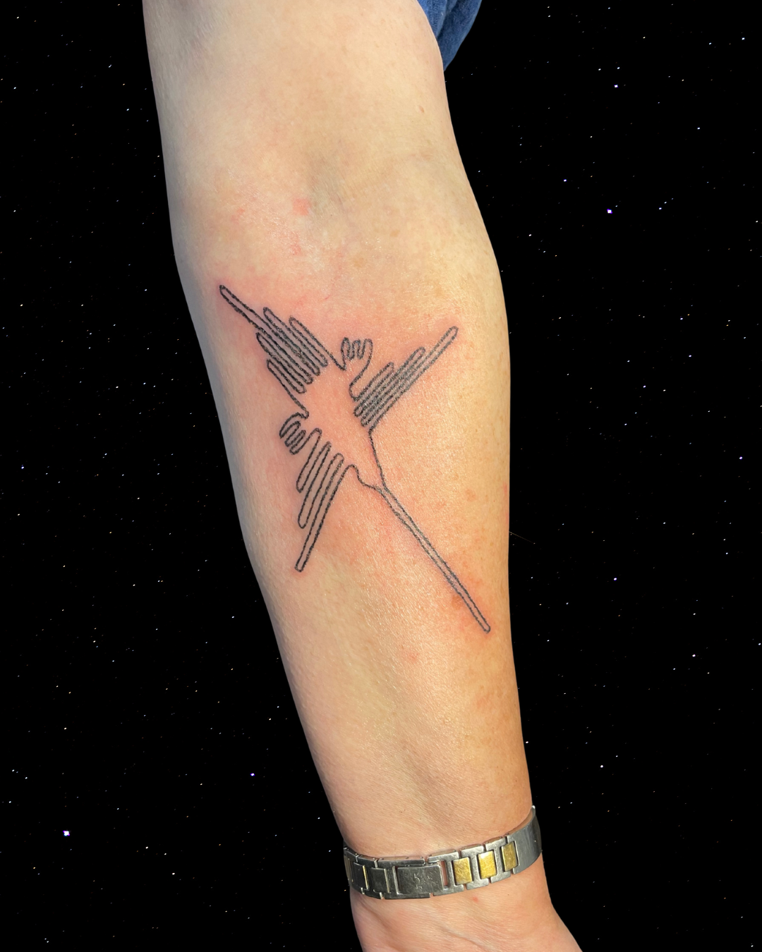 Hand Poked Tattoo of the humminbird from the lines of Nazca