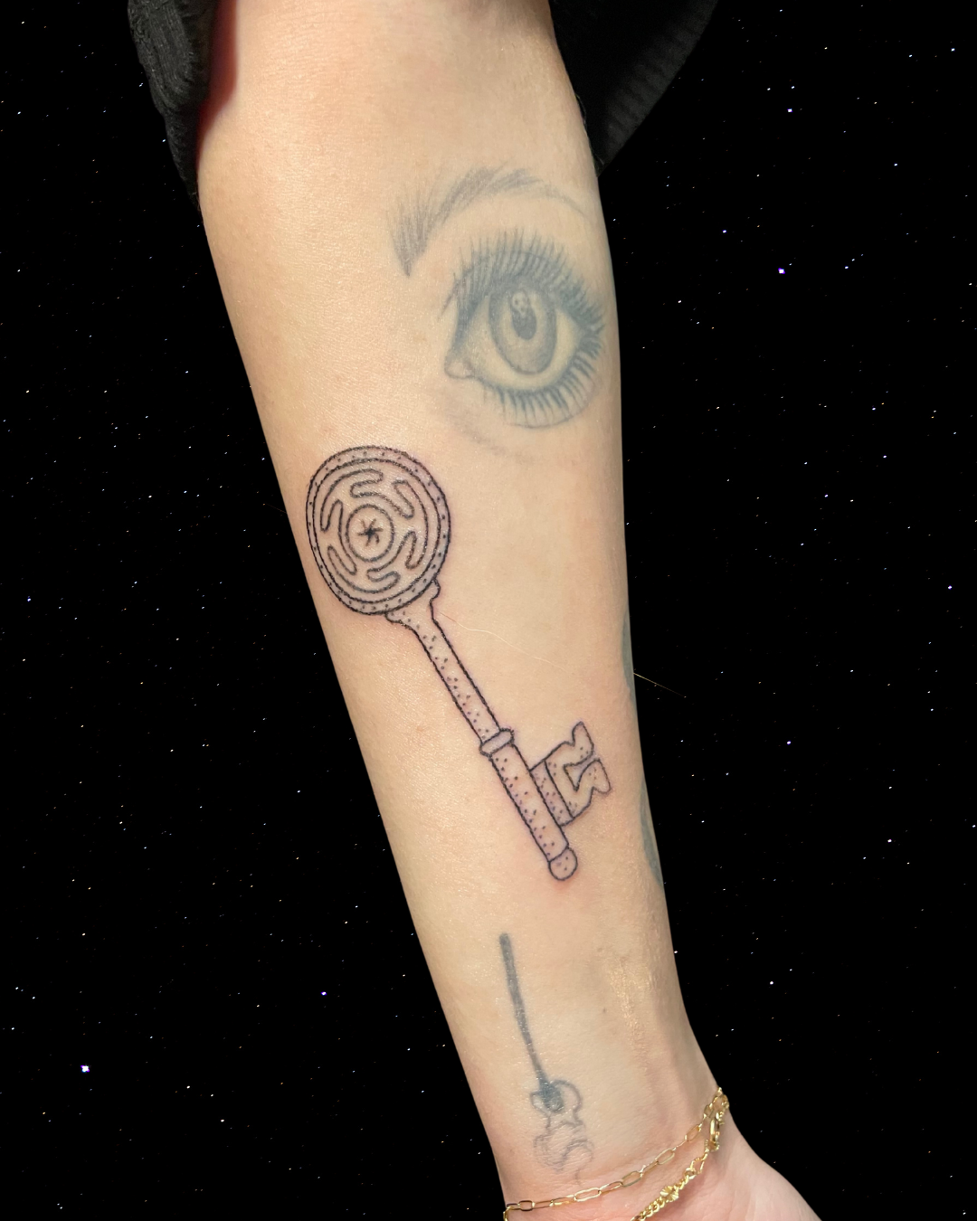 Hand Poked Tattoo of Hekate's Wheel and Key on a forearm